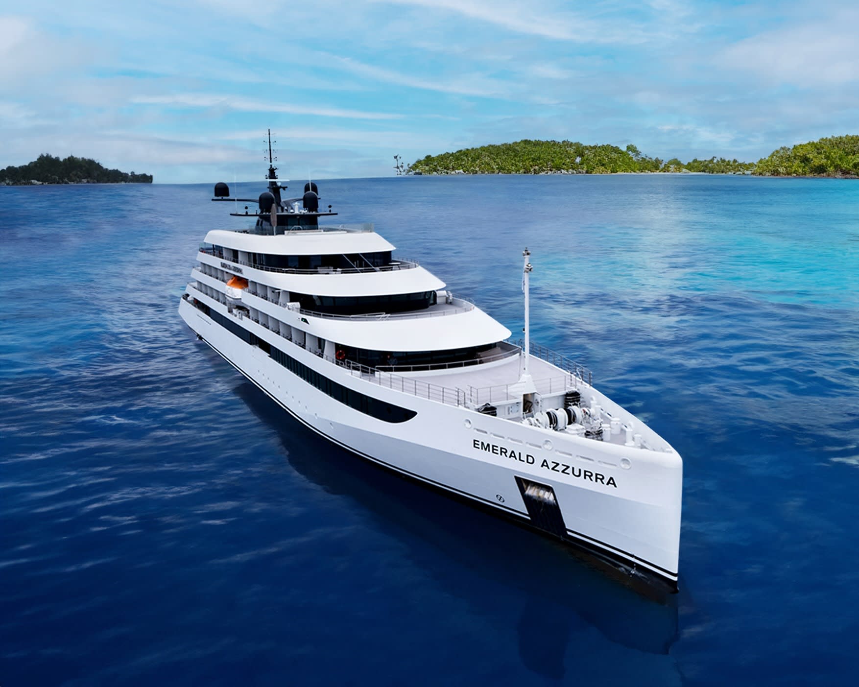 a white yacht in blue waters off a tropical island coast