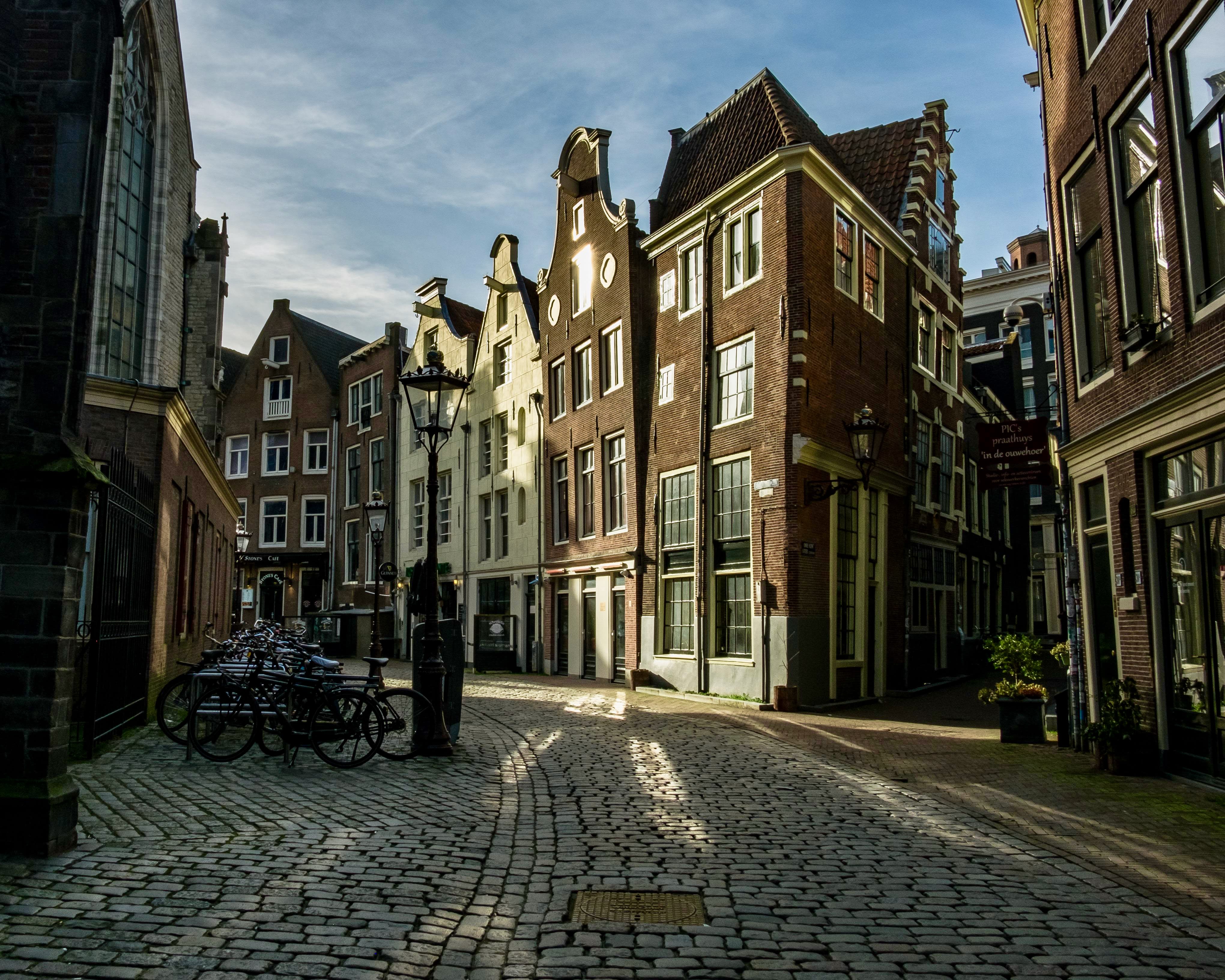 brick buildings and cobblestone streets in a city's old town during day