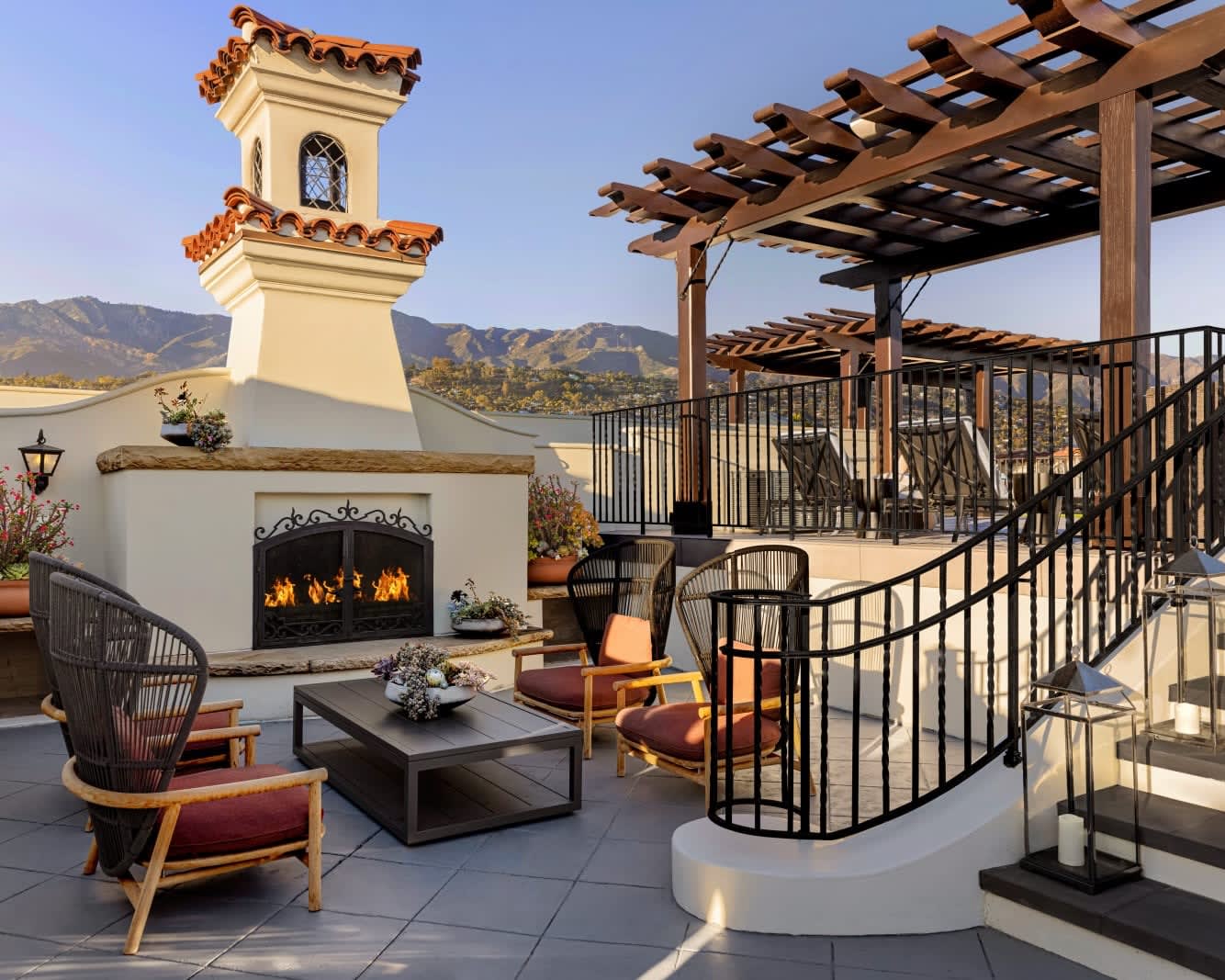 rooftop seating area next to white spanish style fireplace