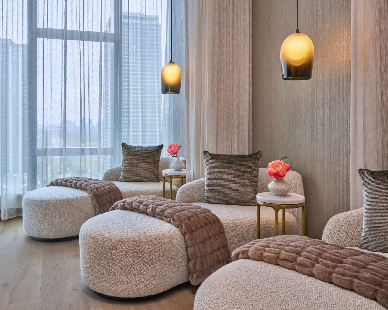 modern plush white lounge chairs with brown fur blanket and grey pillow in a light room