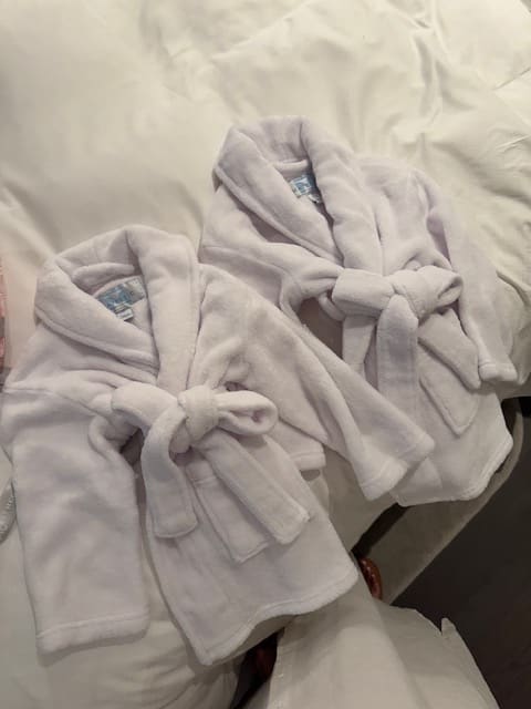 A pair of baby robes for a babymoon planned by Jamie Pond