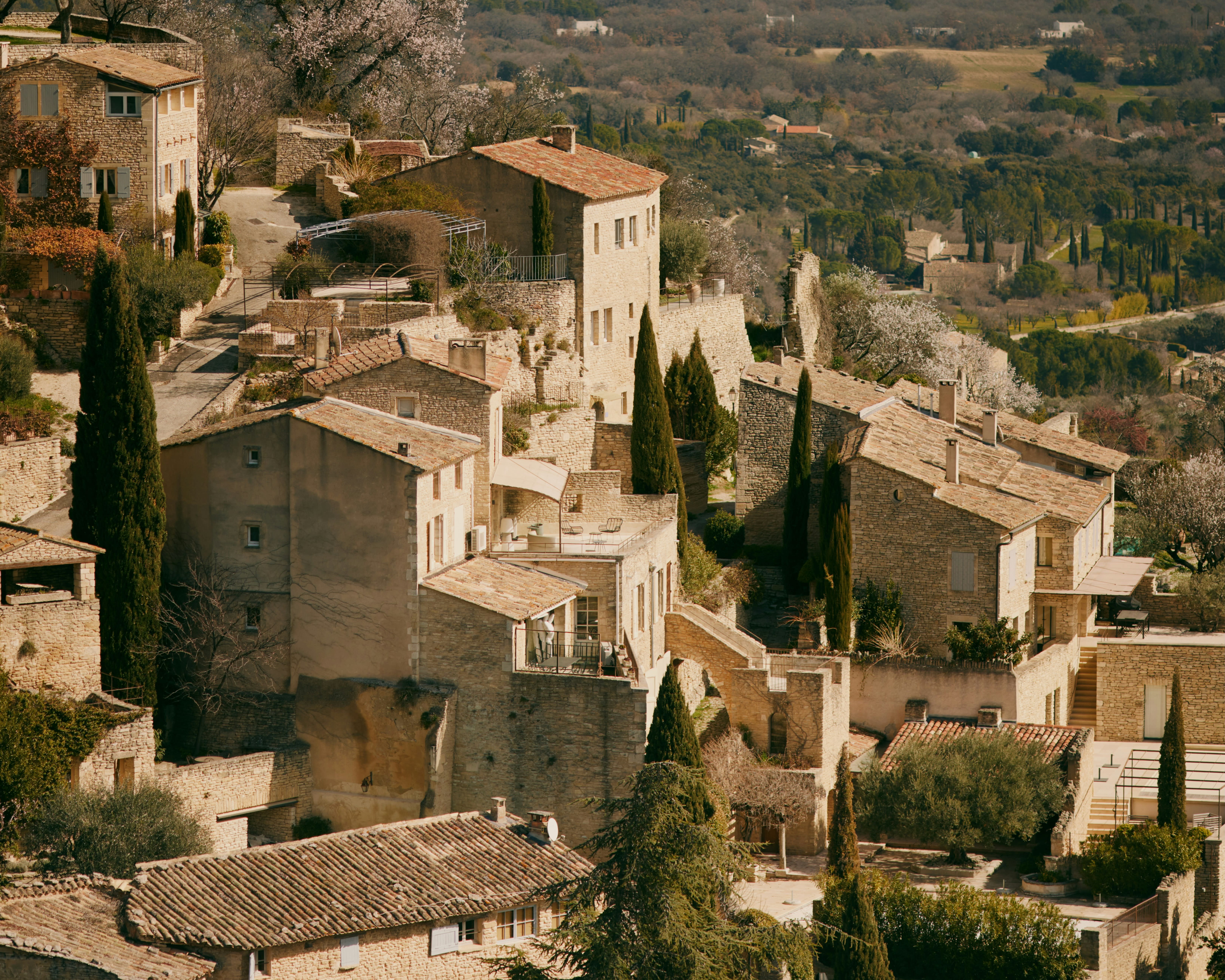 rustic tan stone homes forming a hillside village