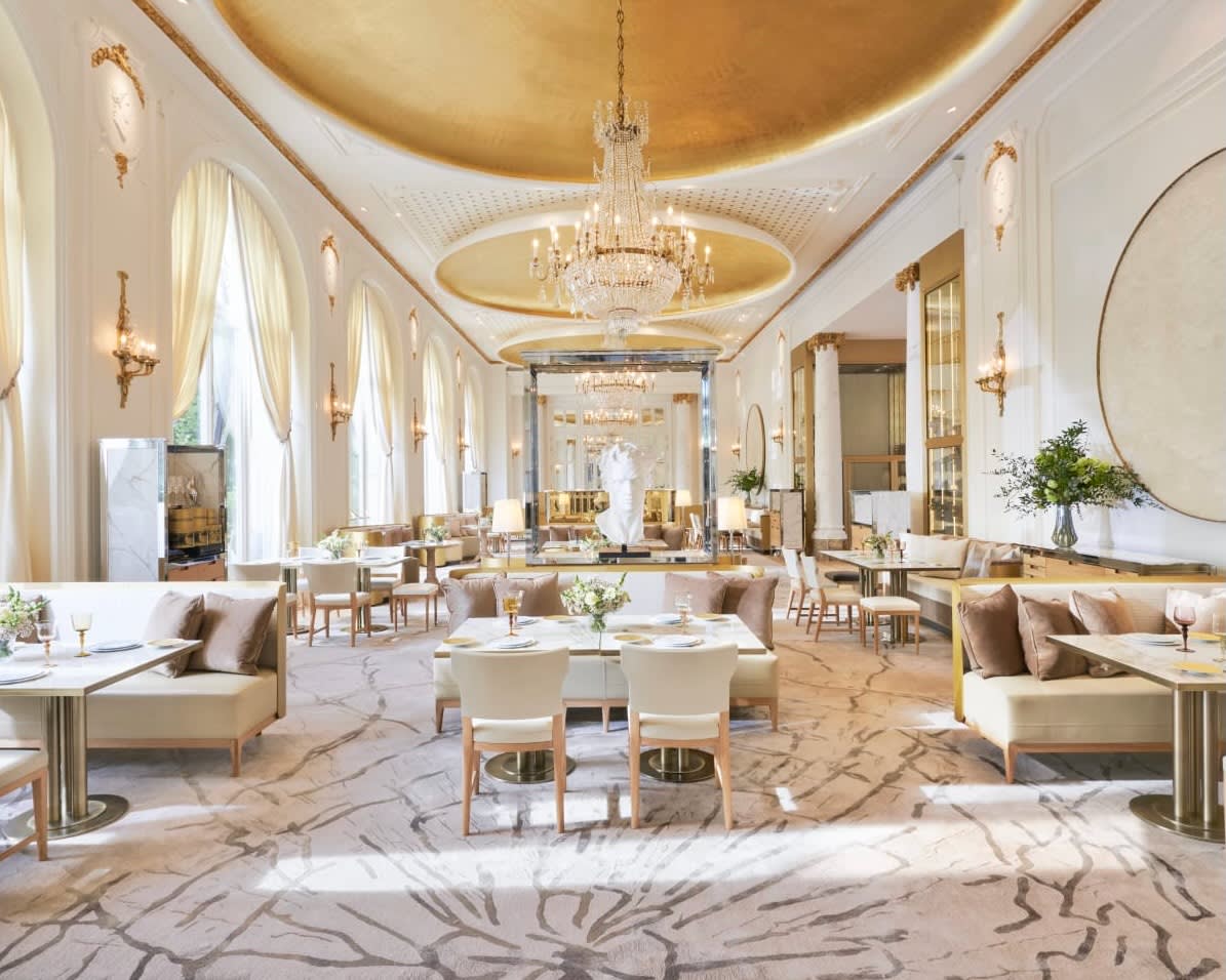 white modern restaurant with gold ceiling and chandelier