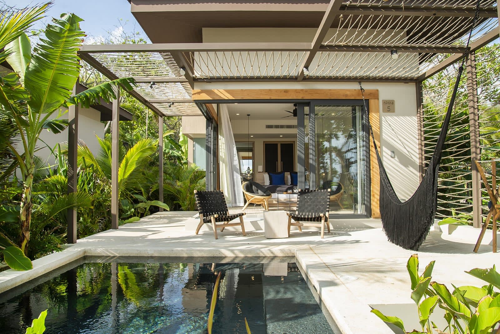 private pool villa with black hammock and chair