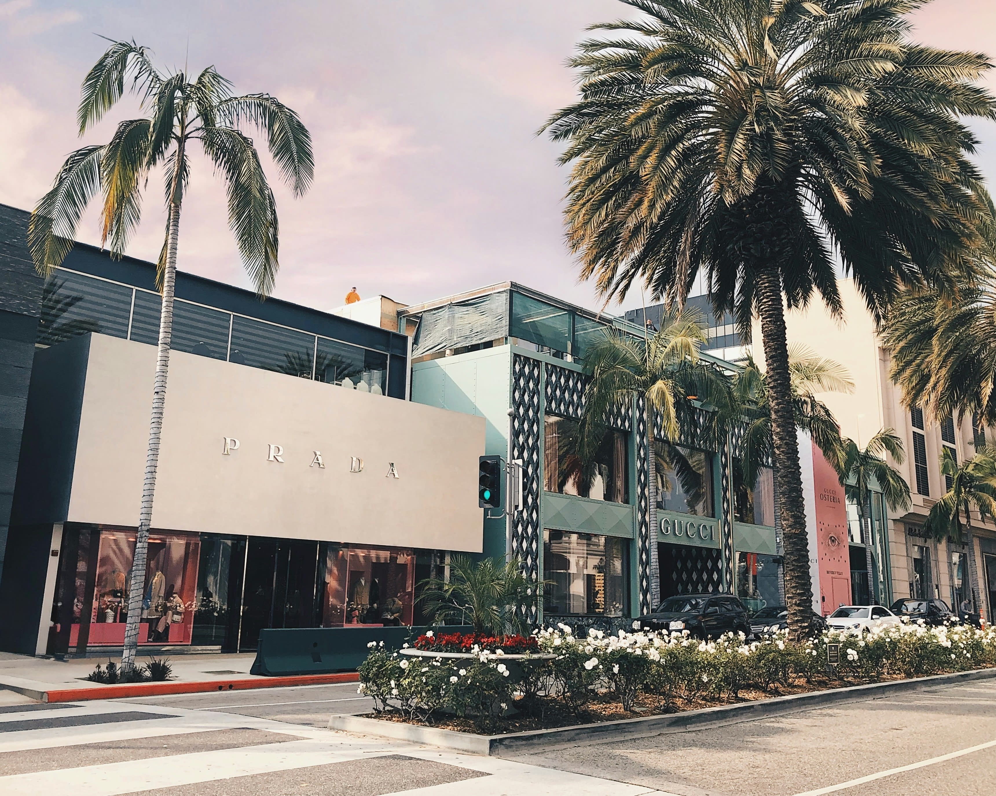 street lined with luxury designer stores and palm trees