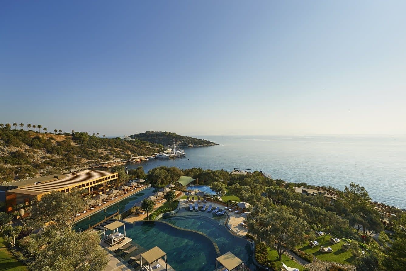 An aerial photo of the Mandarin Oriental, Bodrum hotel showing a pool and the coastline
