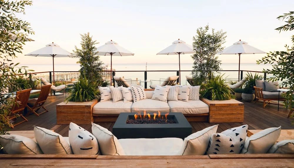 Outdoor couches and a firepit at the Surfrider Malibu hotel