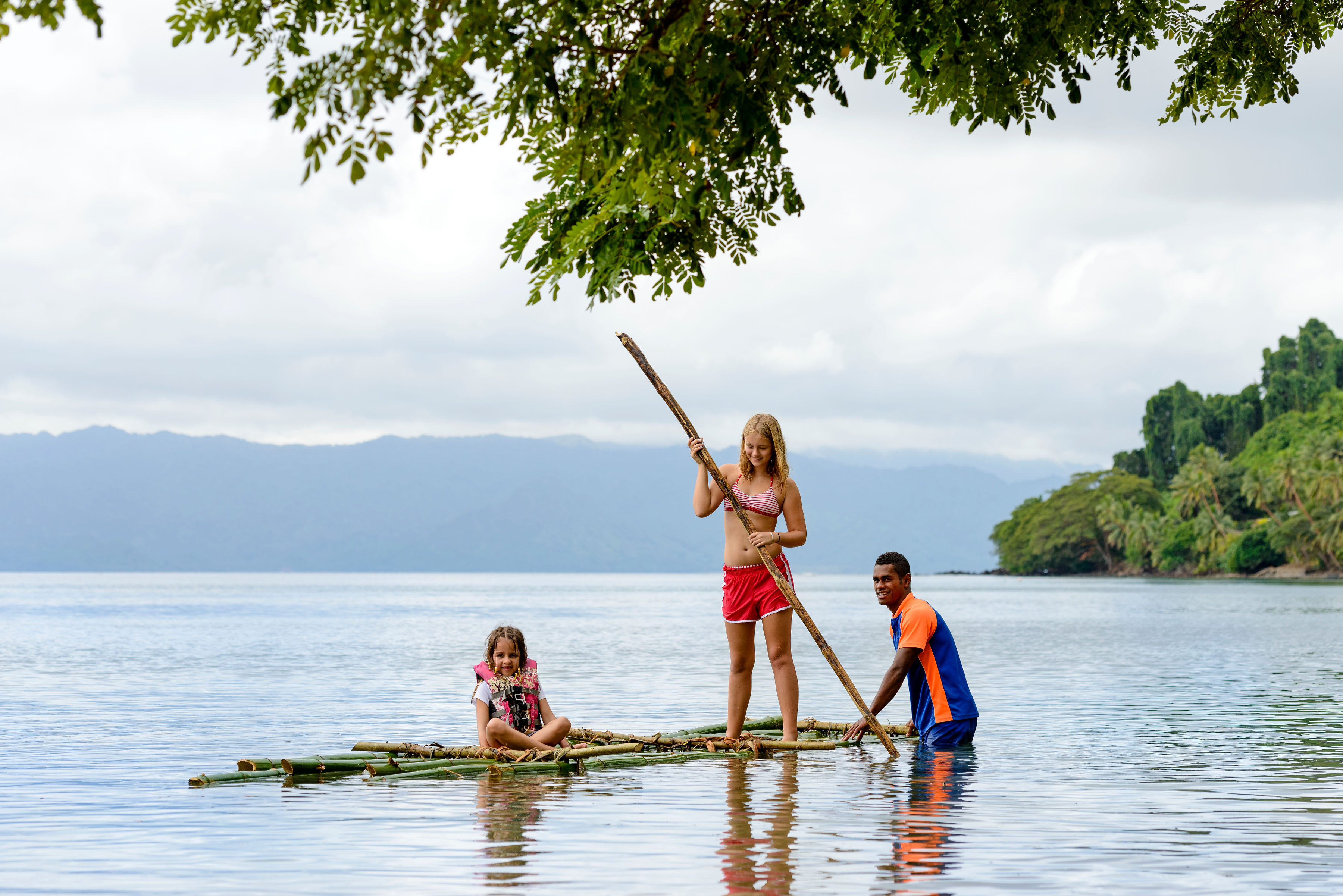 Two children get a paddleboarding lesson at Jean-Michel Cousteau Resort in Fiji
