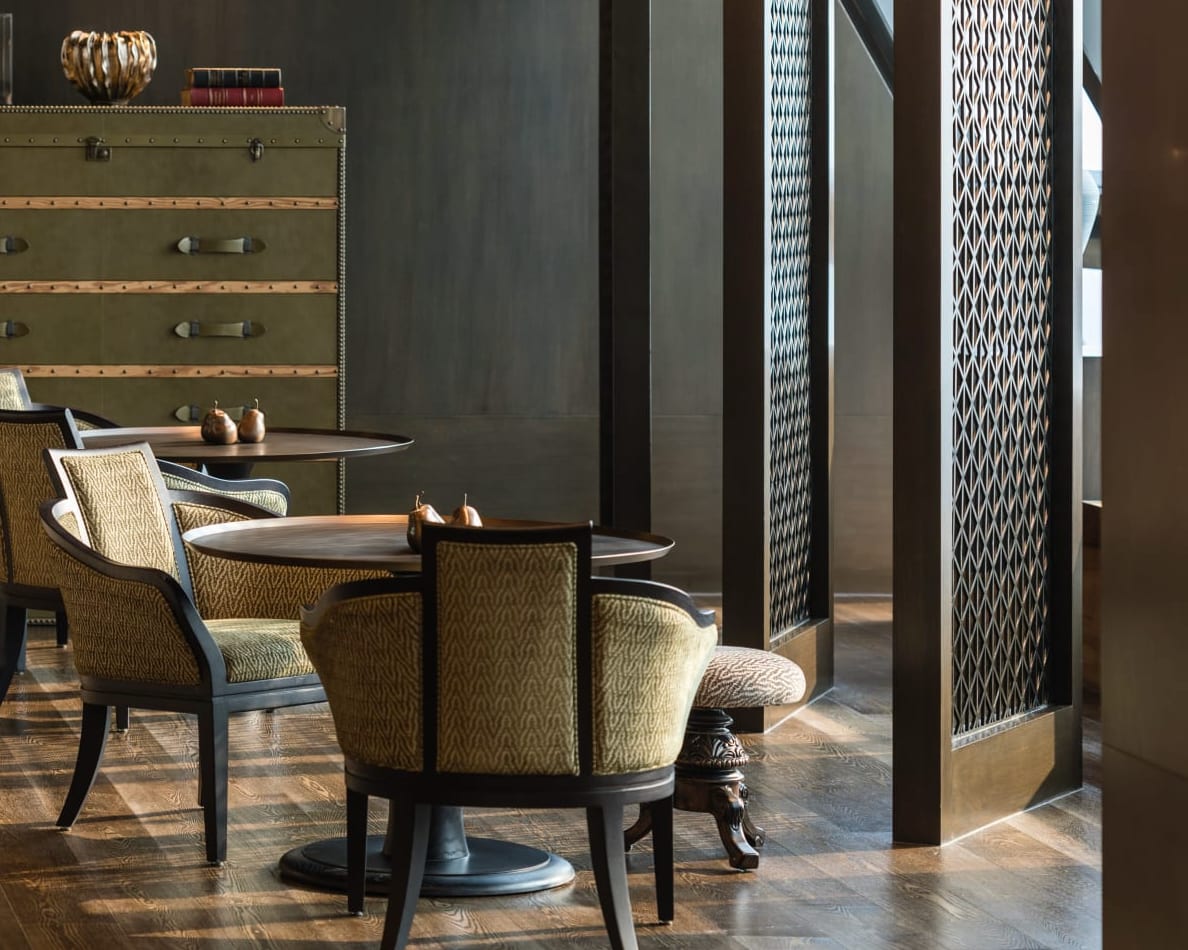 gold chairs in front of dark brown wood panels