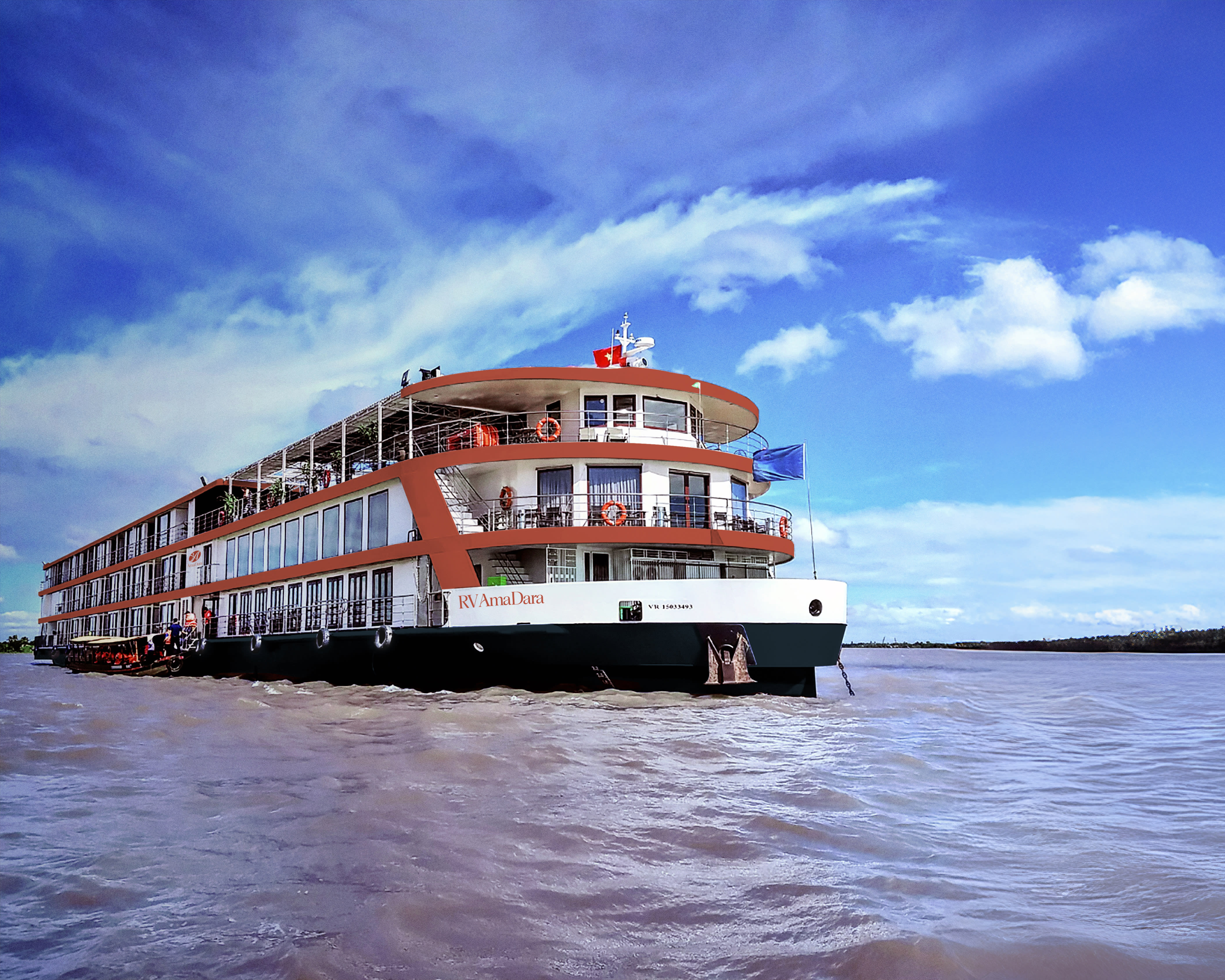 a three storey white and brown river cruise on the water during day