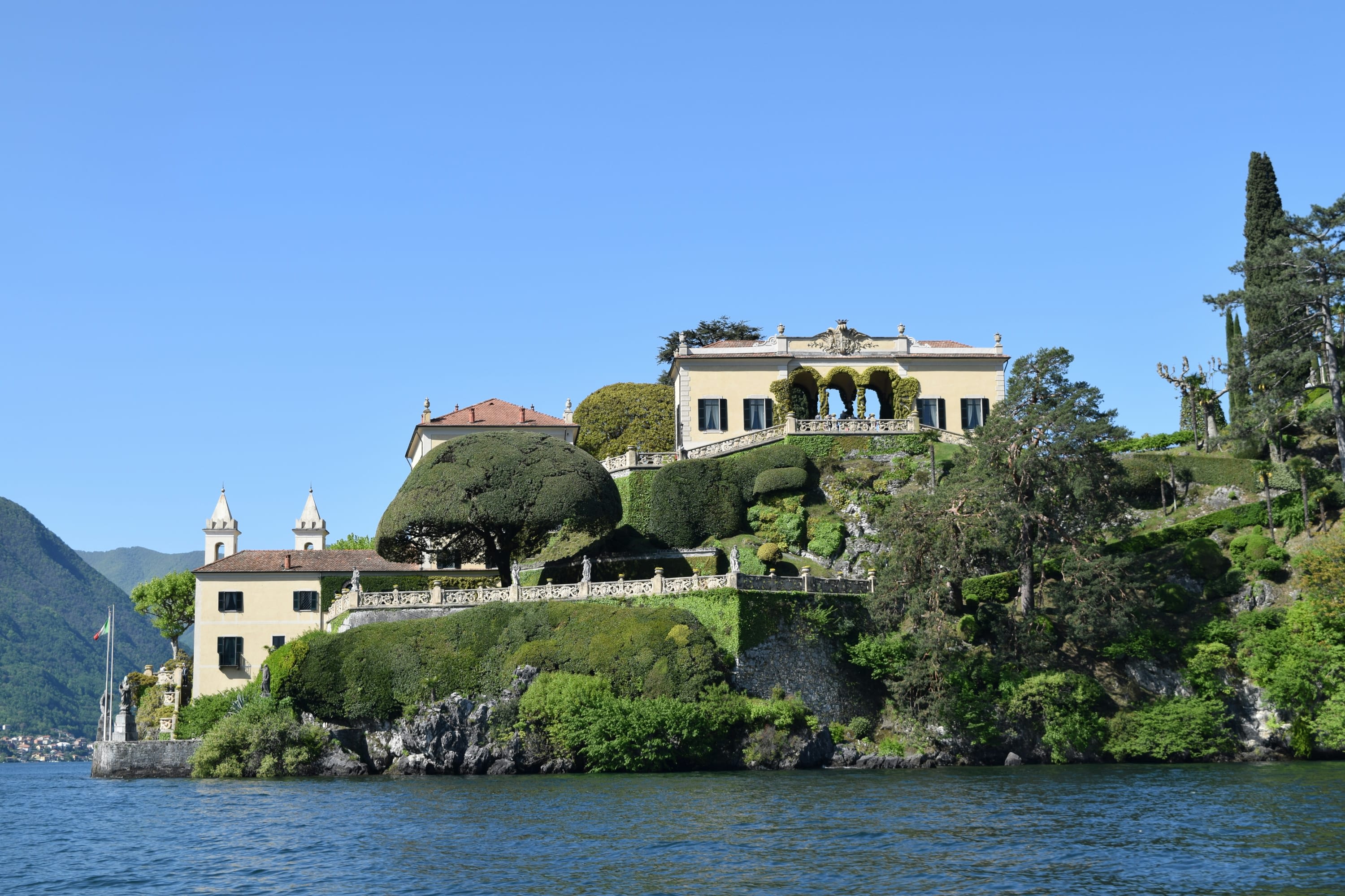 Classical Old World villa rising several levels along the forested shores of Lake Como