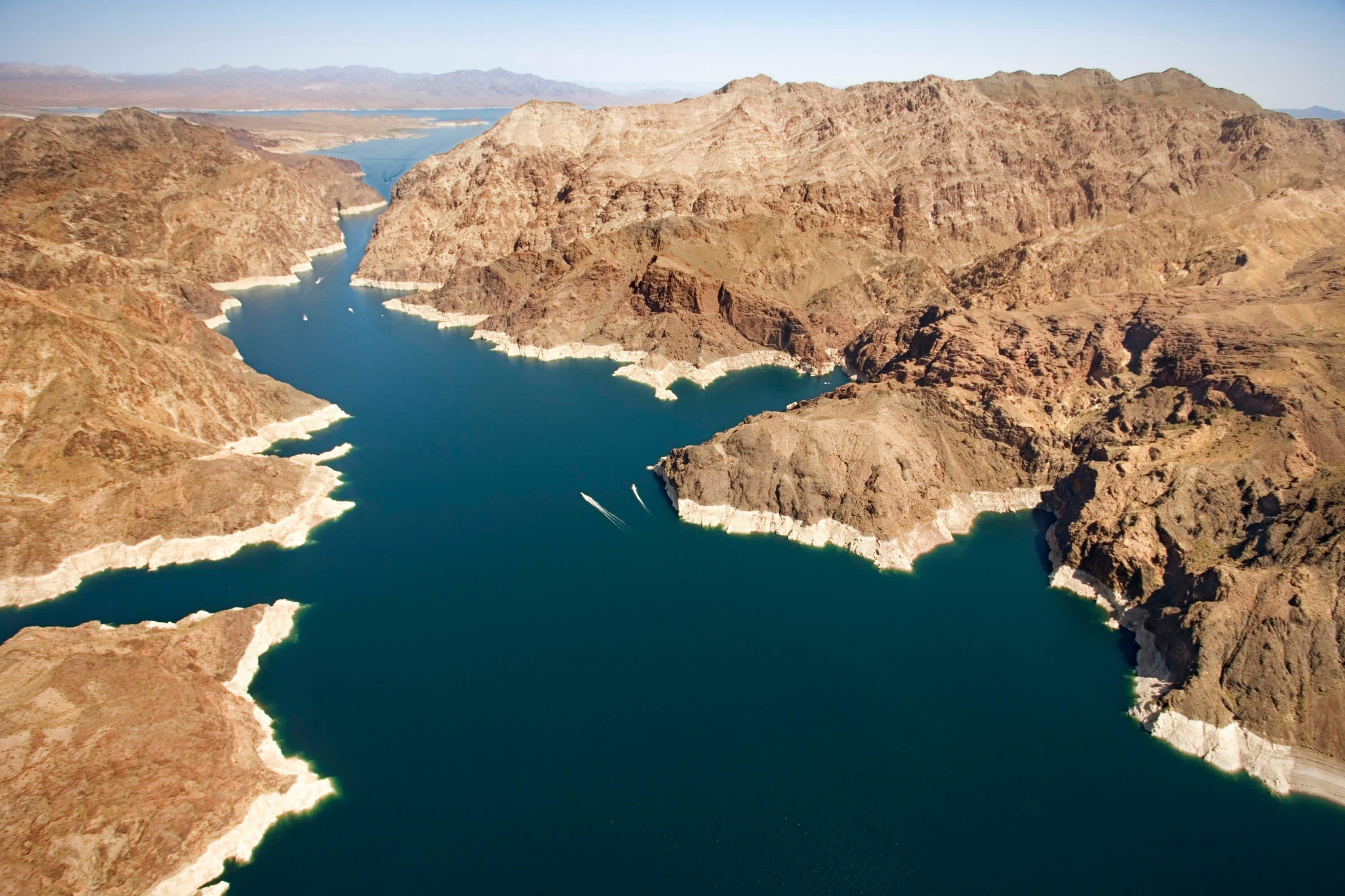 Rocky peaks surround deep blue water. The rock is lighter near the waterline, showing that the lake has lost a lot of water recently