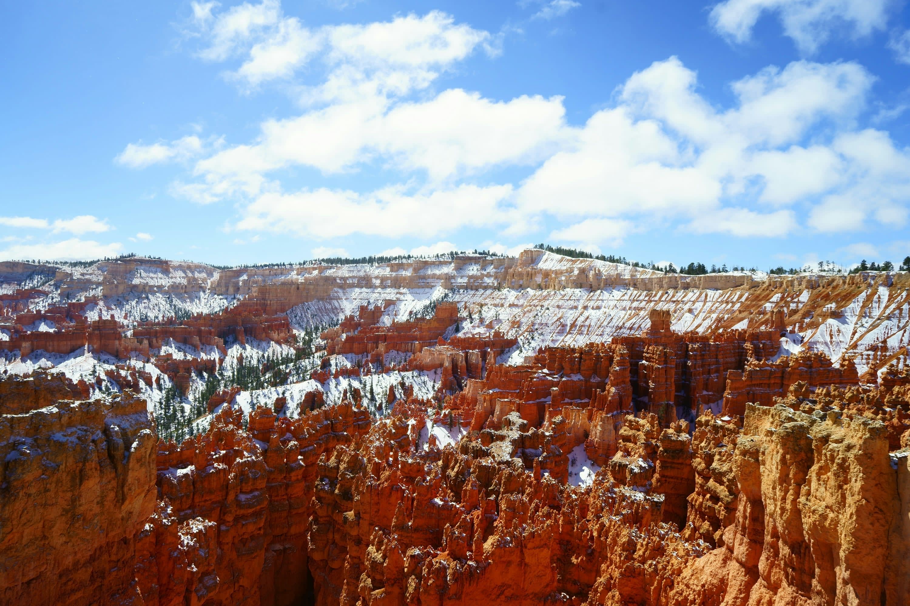 Snow caps cascading flat, red mountain peaks