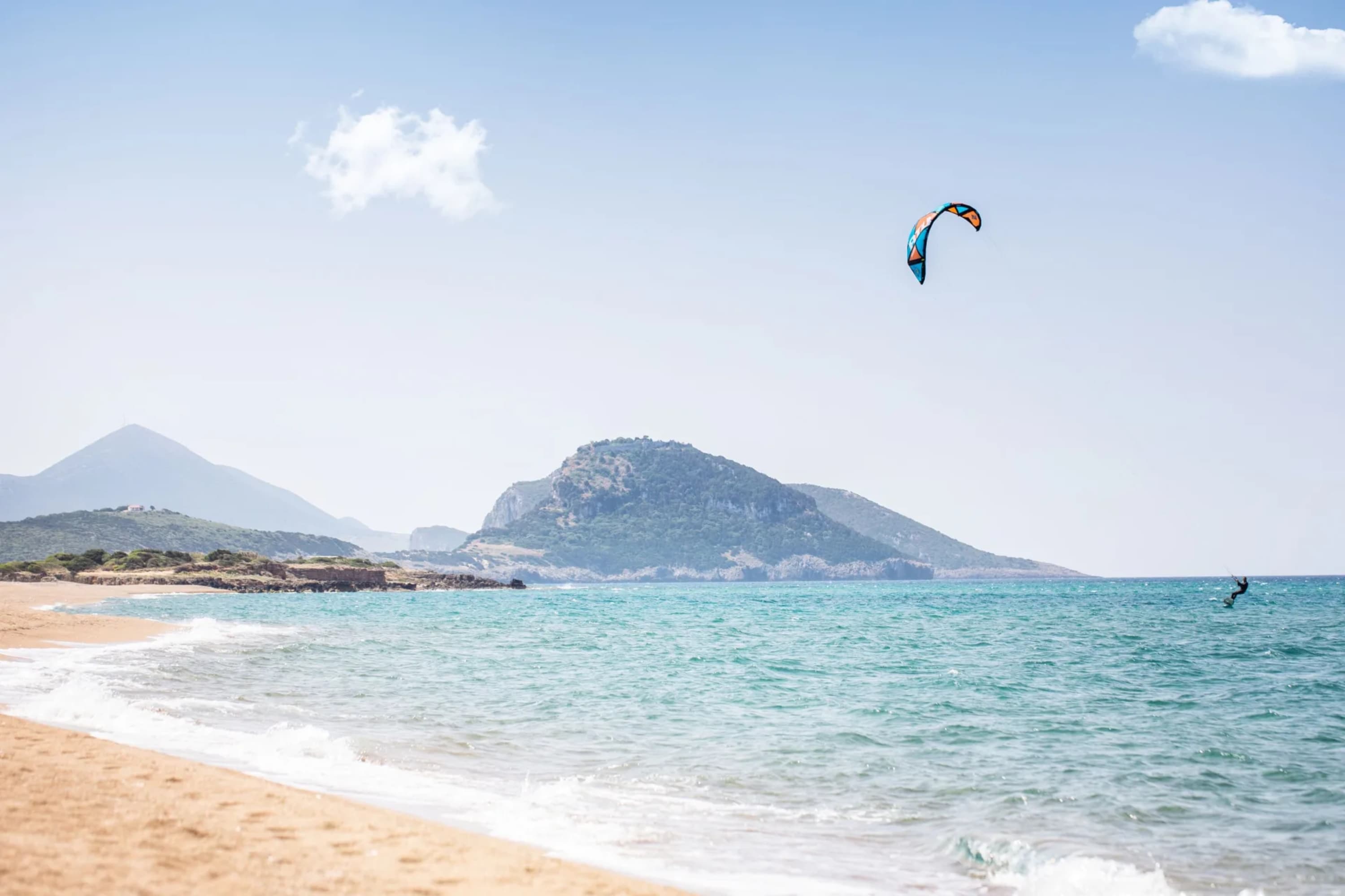 A lone parasailer riding the waves somewhere off the shores of Pylos, Greece