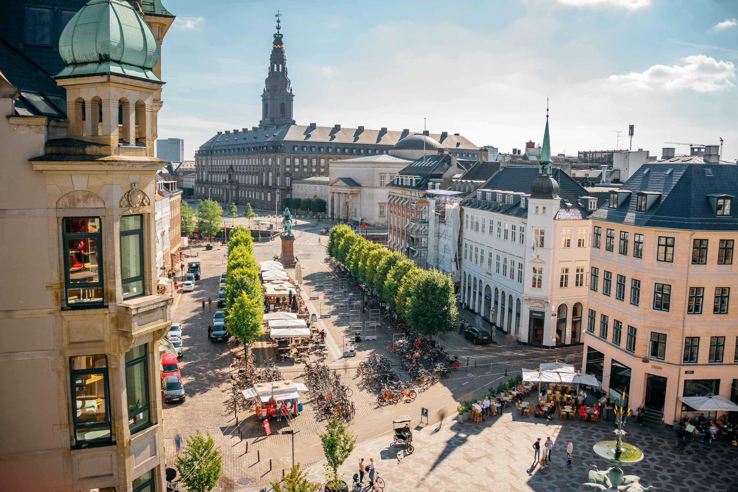 From an elevate viewpoint: clean streets separate historical buildings lined with bikes