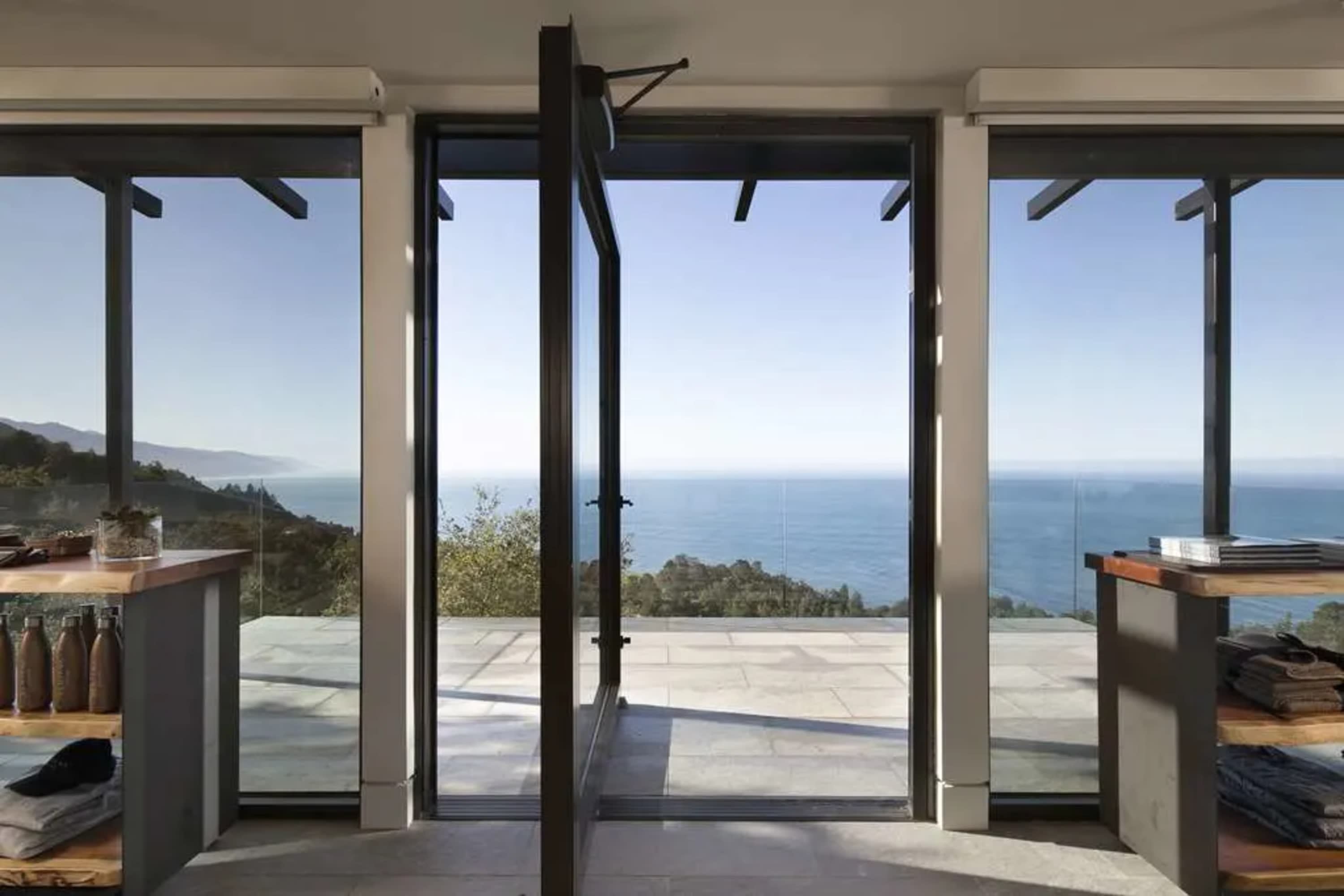 Floor-to-ceiling windows reveal the Big Sur coastline