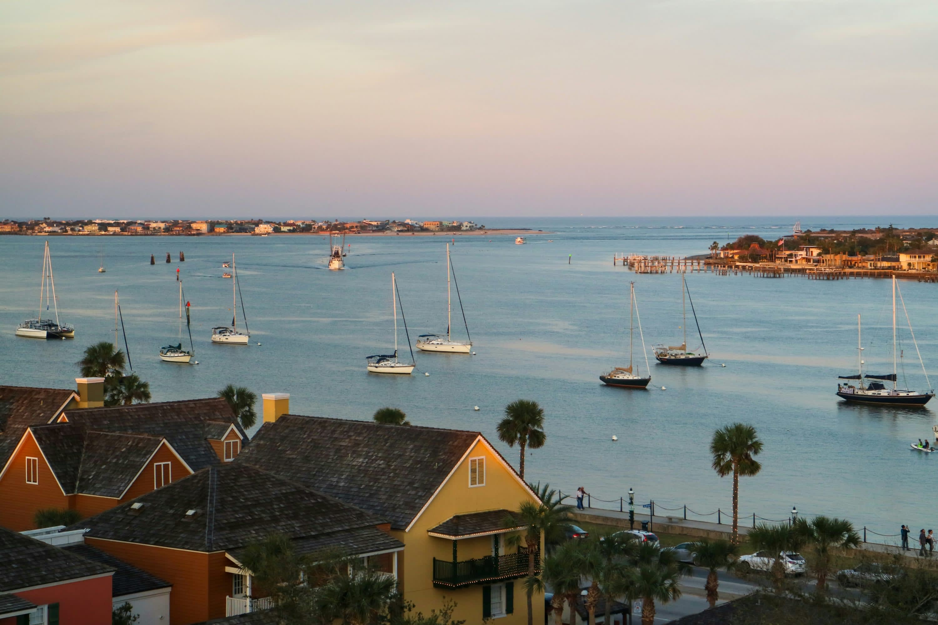 At sunset: sailboats are moored off the coast of St. Augustine in a small harbor