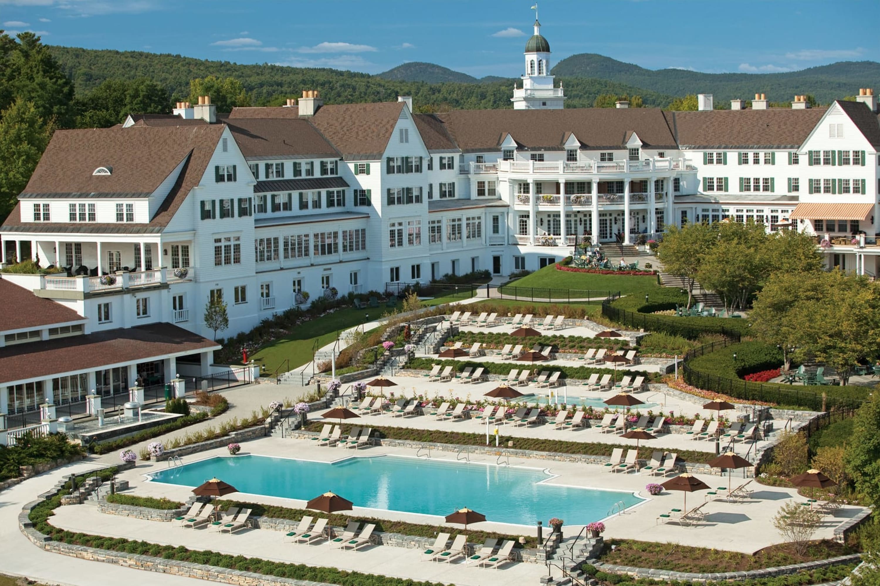 New England-style beach architecture with a large pool complex