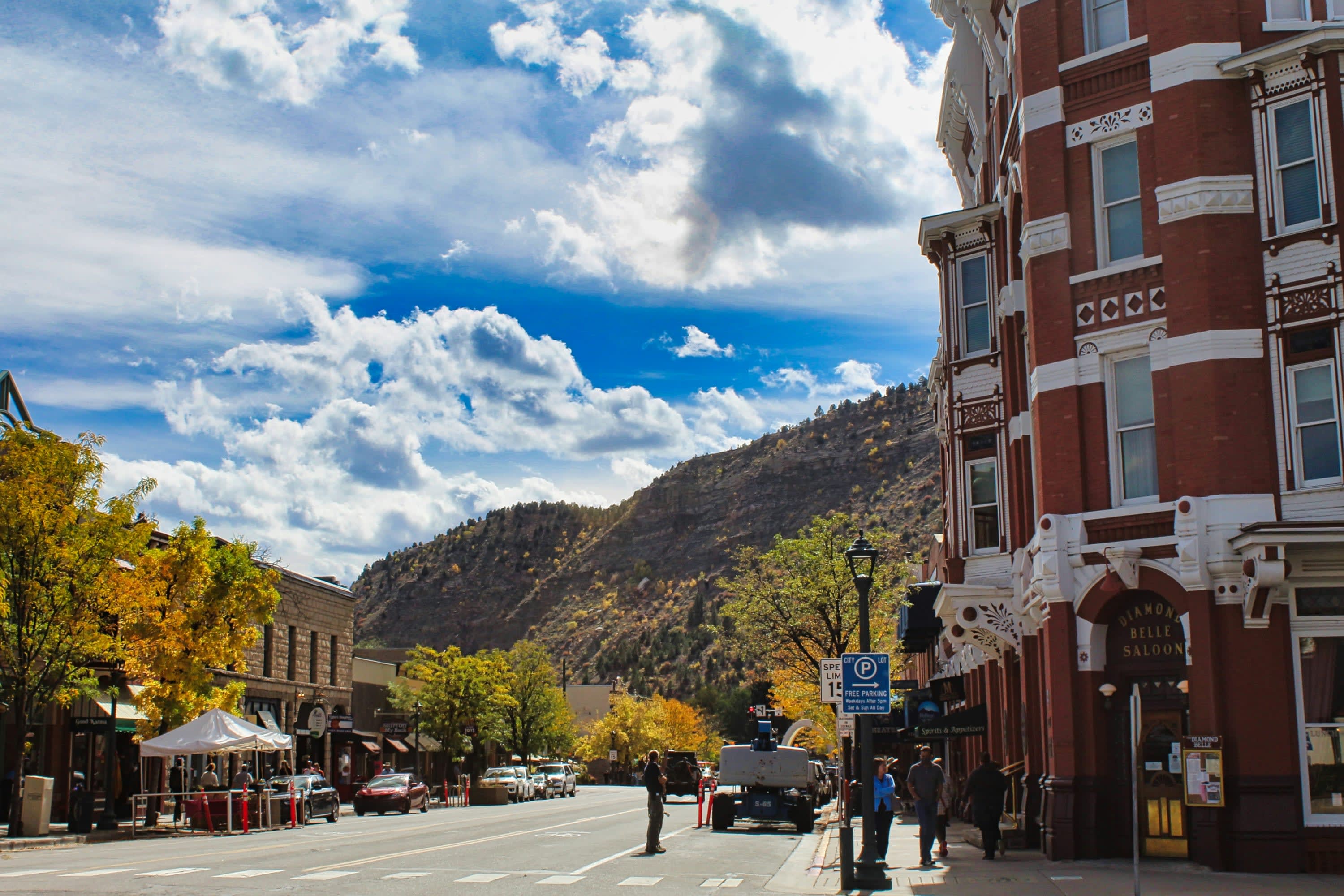 Quiet streetcorner in Durango, Colorado with mountains in the background and a big sky, partly cloudy
