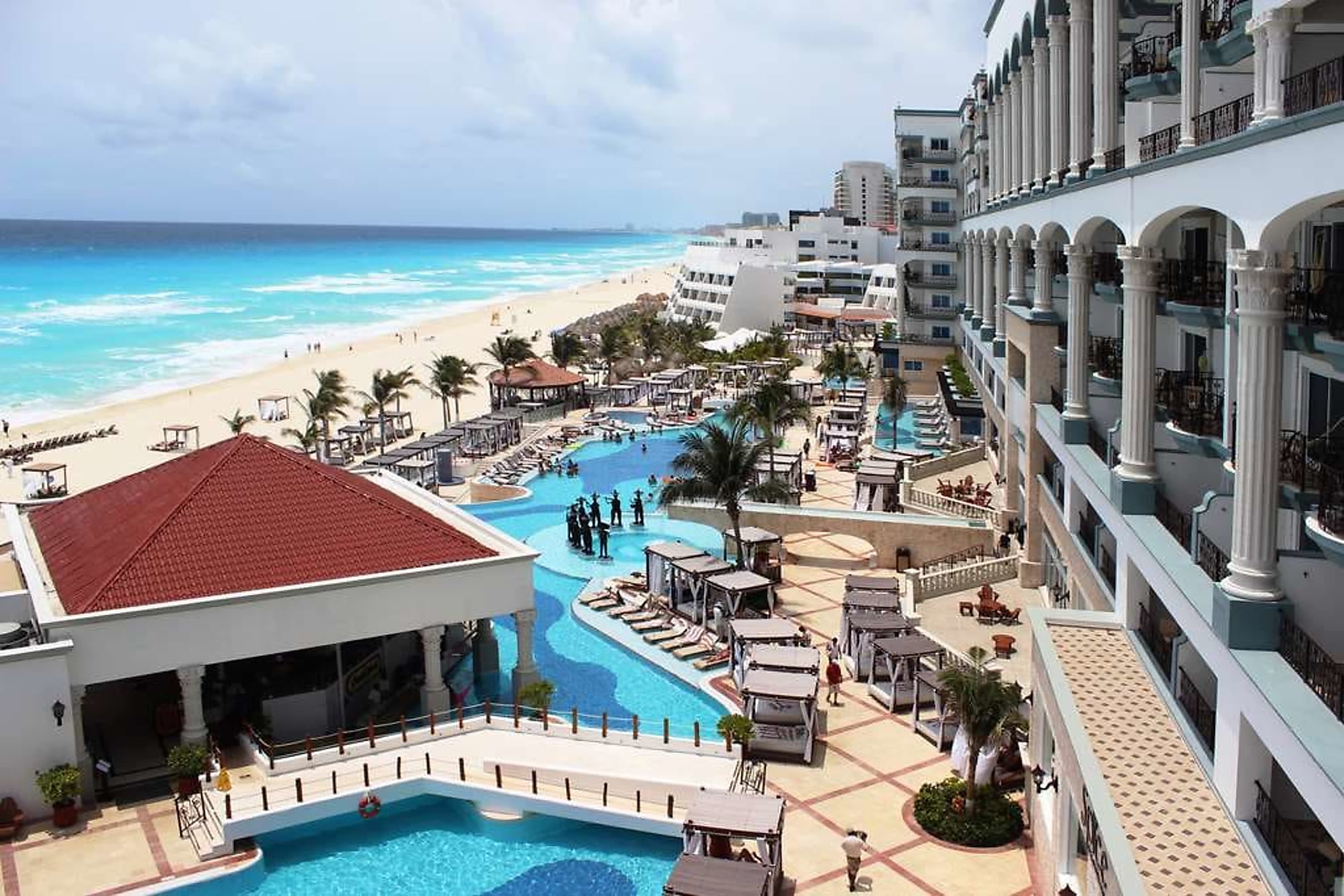 Chic pool area with a footbridge leading to a beach with rough but beautiful surf