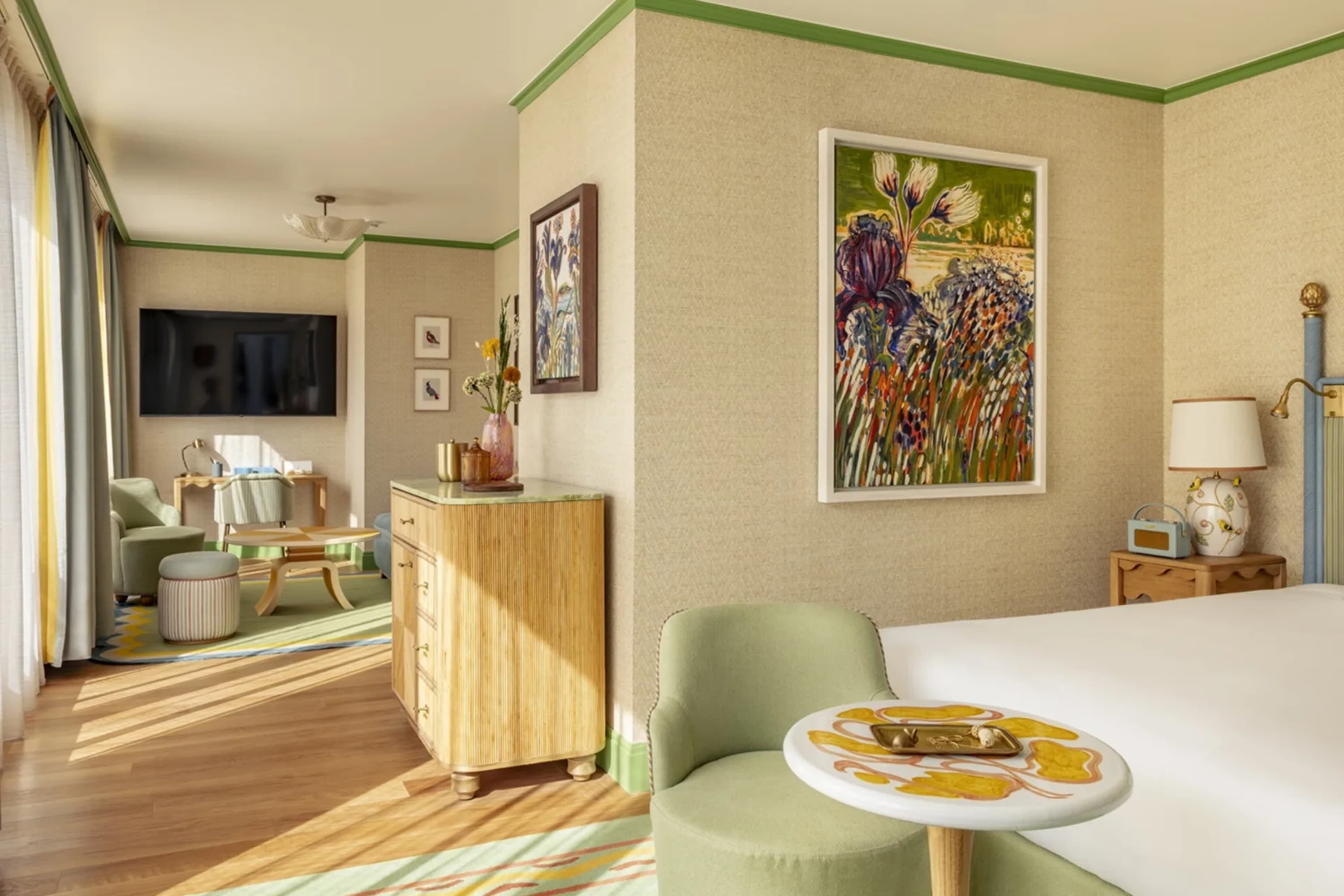 Spacious hotel suite with a chic, natural aesthetic. Soft greens and natural earth tones are common