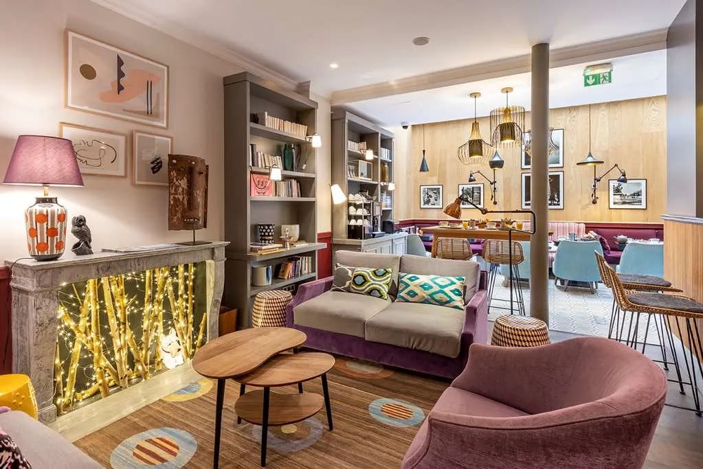 Stylish living room area with a very residential but clean feel. Pops of color and chic, eclectic decor permeate the space