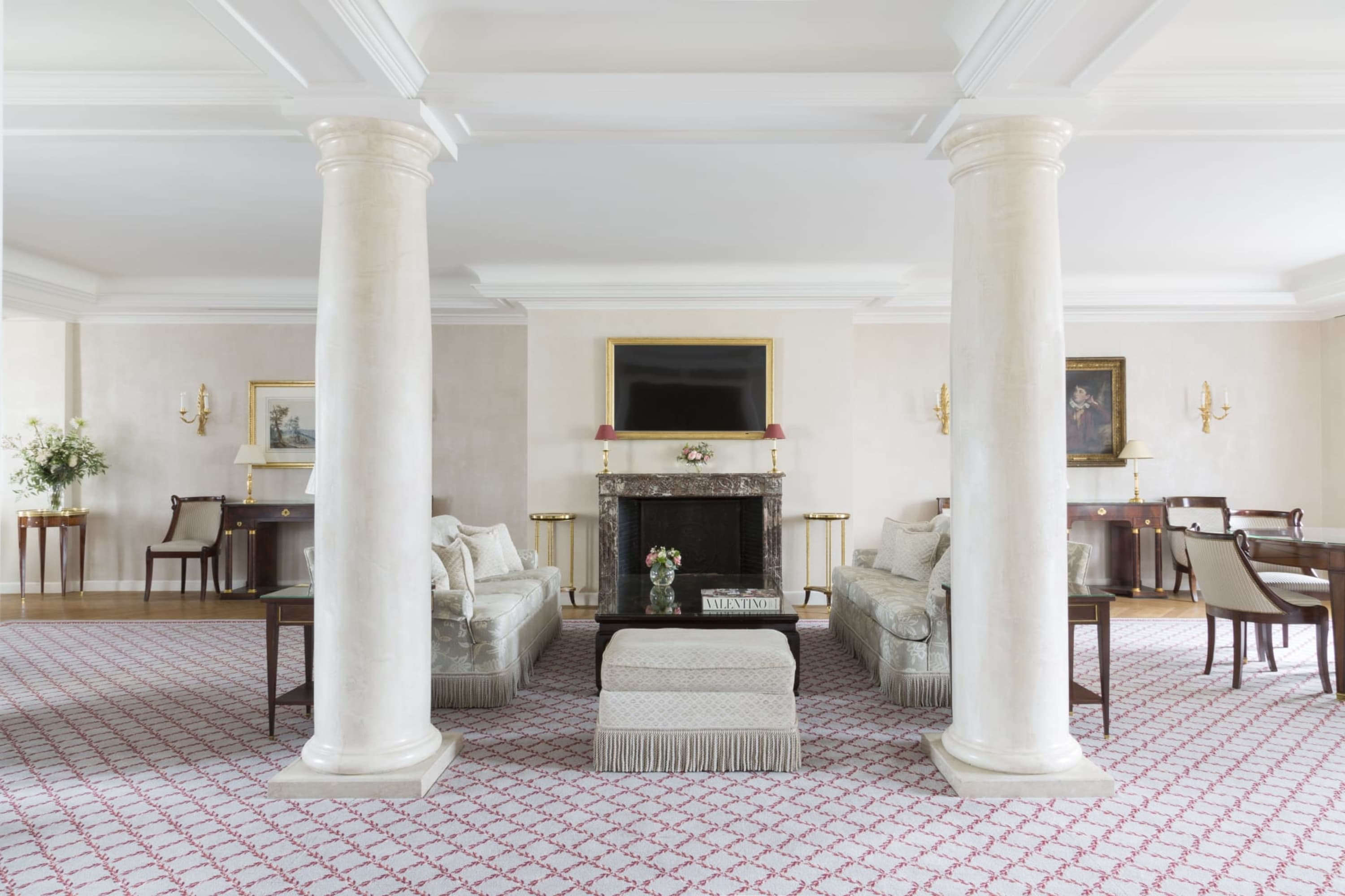 Columns stand in the middle, but don't interrupt an expansive living room area with elegant furnishings