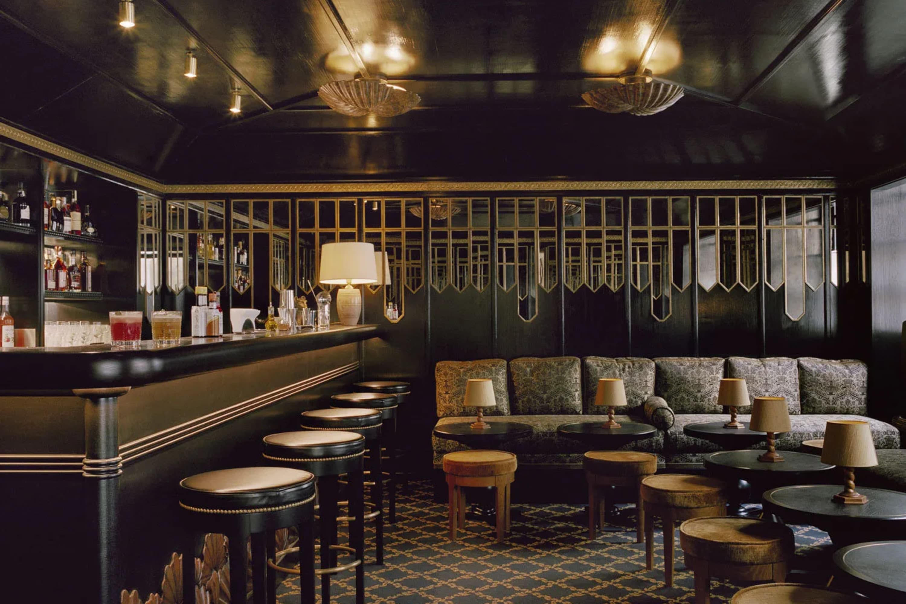Art Deco-style speakeasy gold-leaf ceiling lights, low tables and a high bar