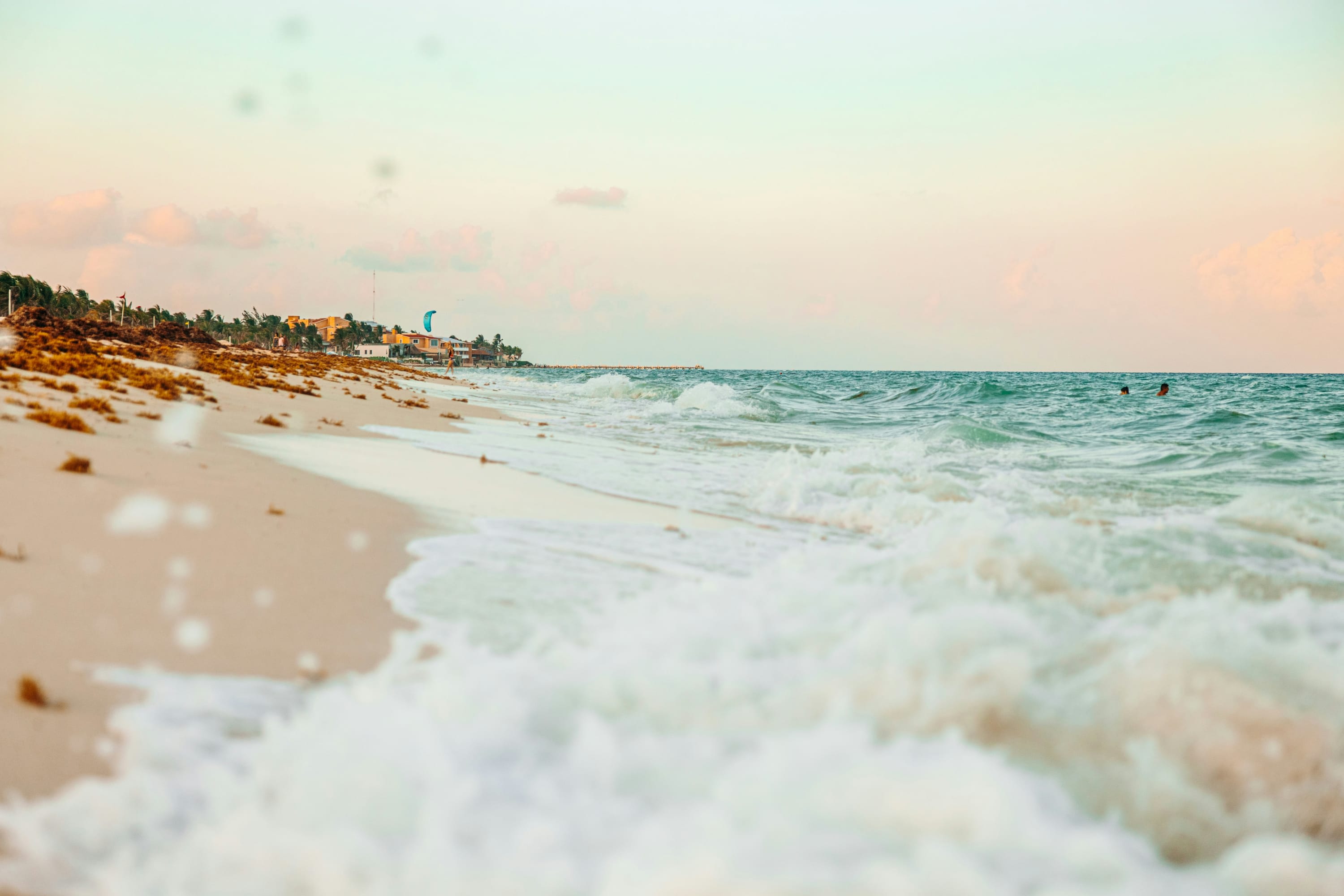 Nearing twilight, a ground-view gives the appearance of rough waves crashing down on an otherwise calm Riviera Maya beach