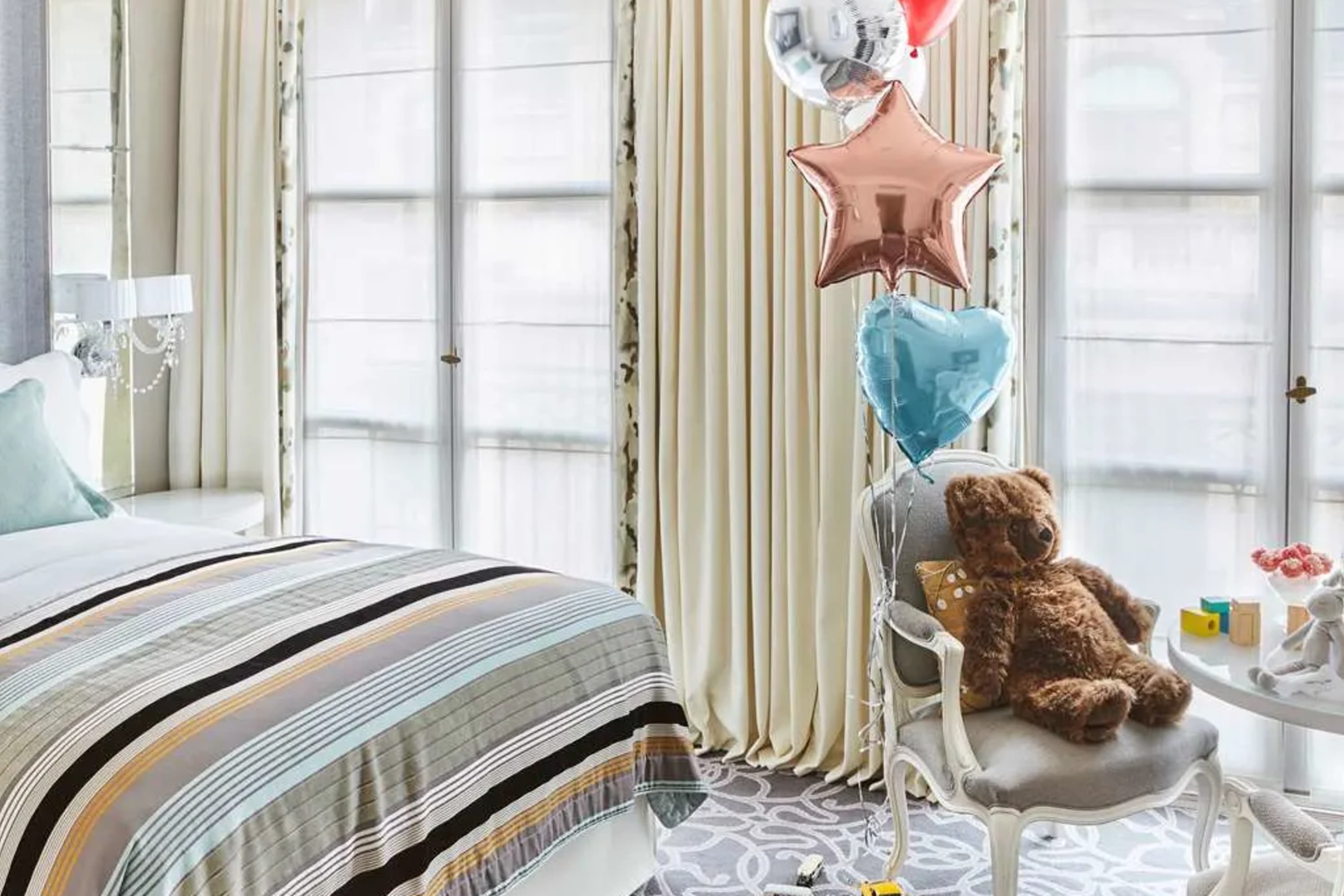 A few toys and balloons adorn an otherwise stylish Parisian hotel room