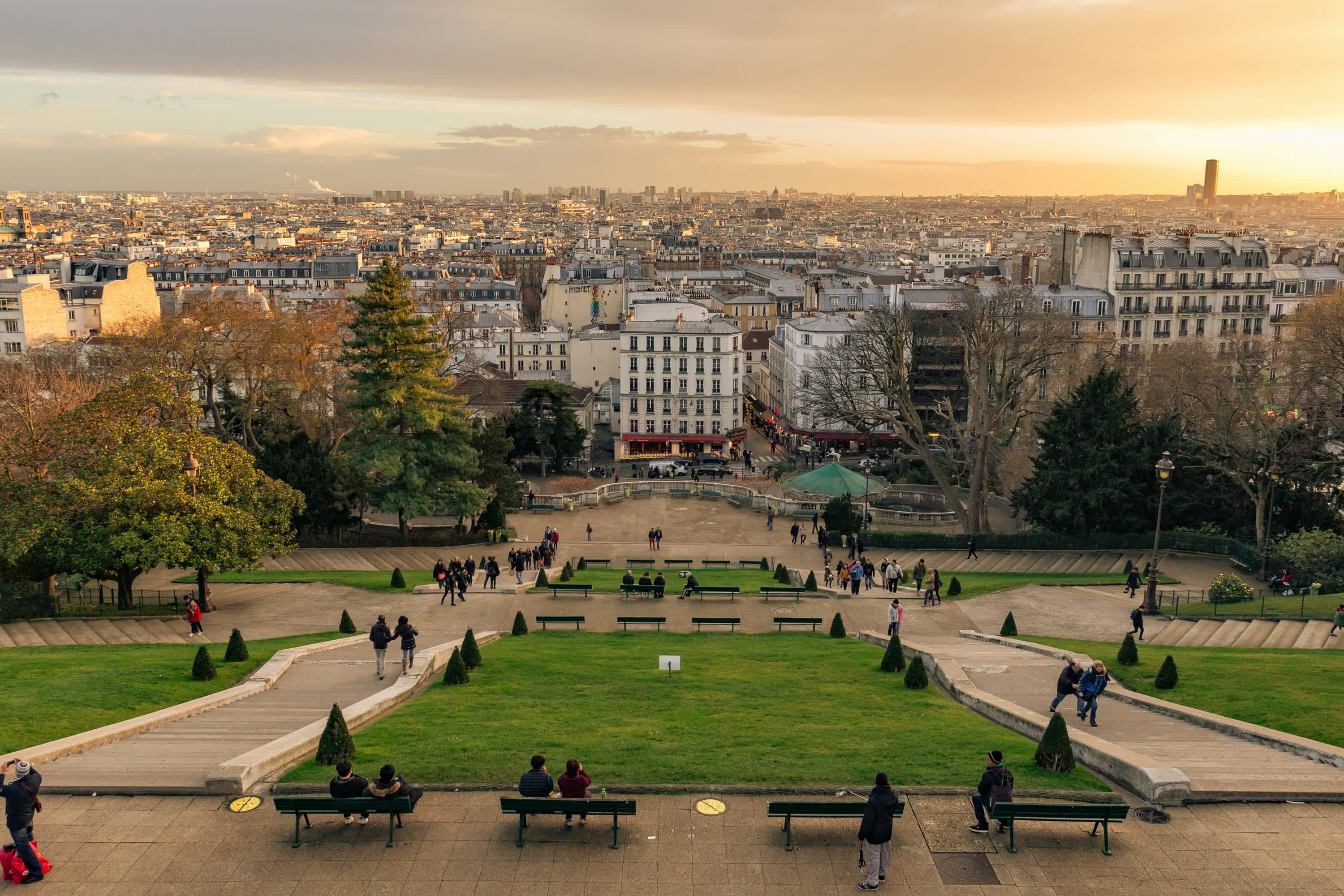 The sun sets over Paris: the camera angels out over a descending greenspace, the hill of Montmartre, out toward a historic skyline