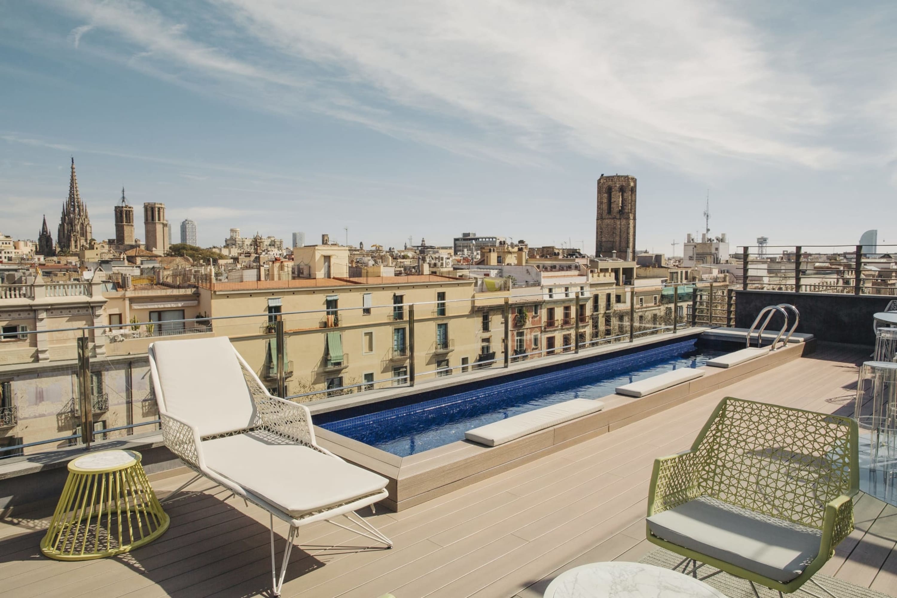 Chic rooftop terrace with a plunge pool near the edge offering a view of historic Barcelona