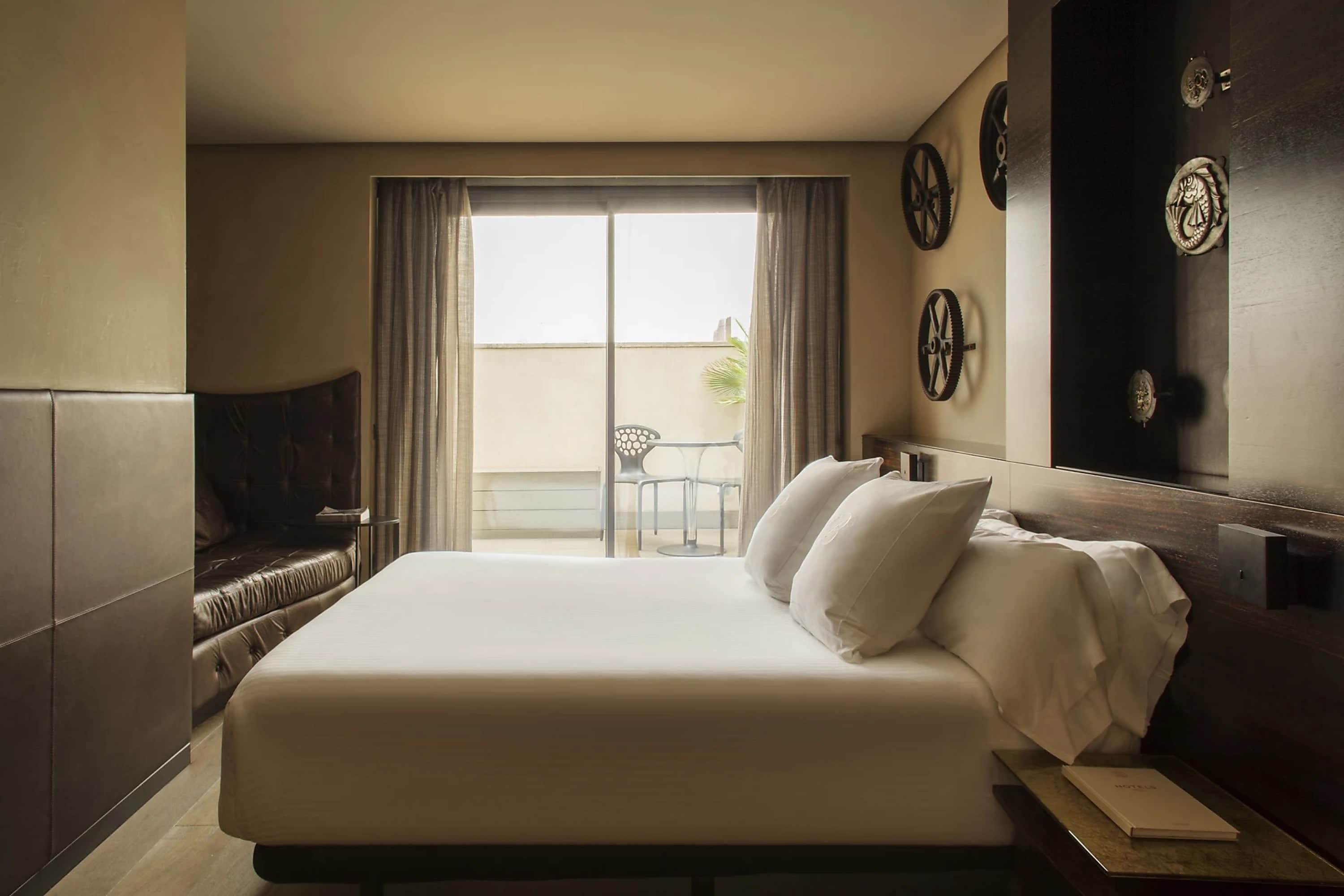 Moody but refined hotel room with eclectic decor and dark color palette