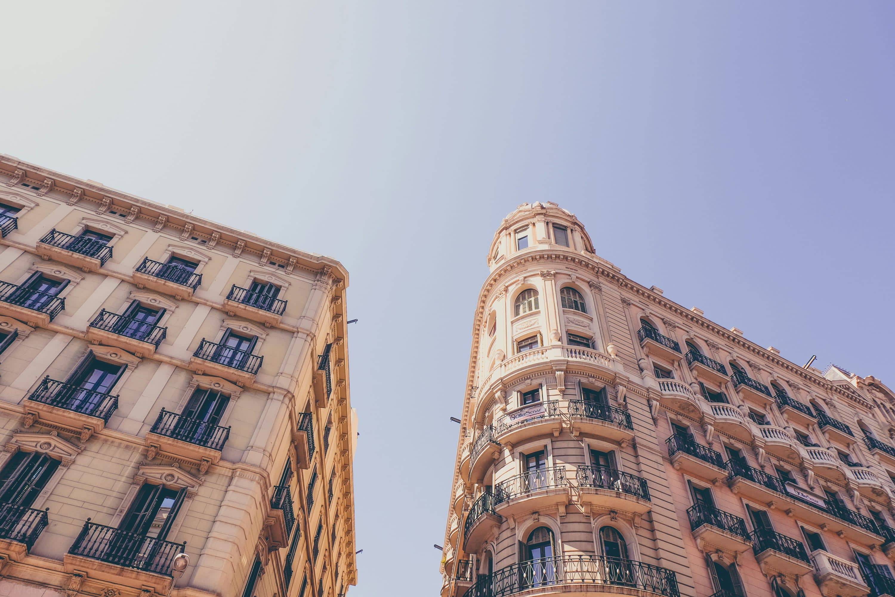 Two historic facades with intricate details on a sunny day