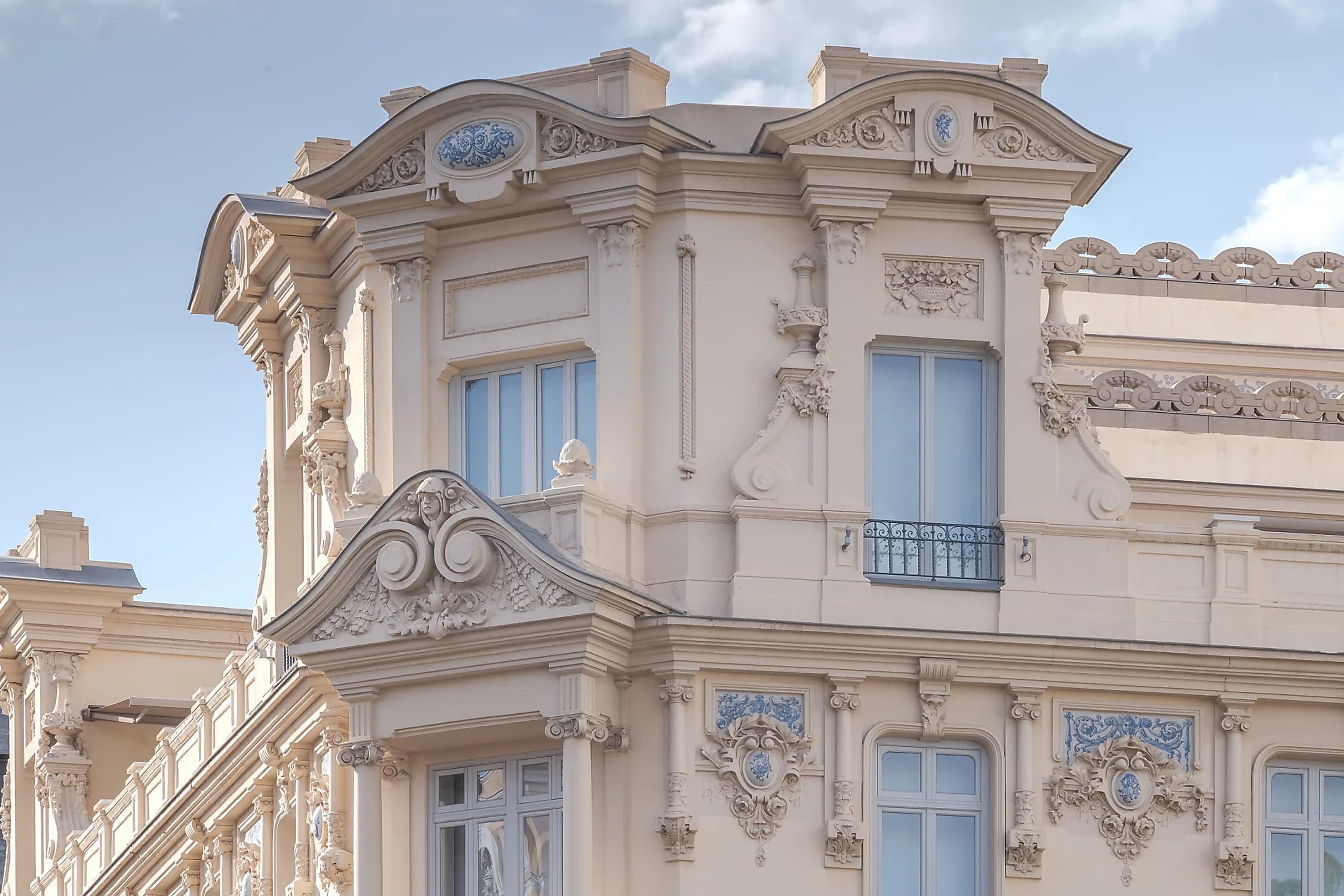 Ornate details are revealed in a closeup on a historic building on a sunny day