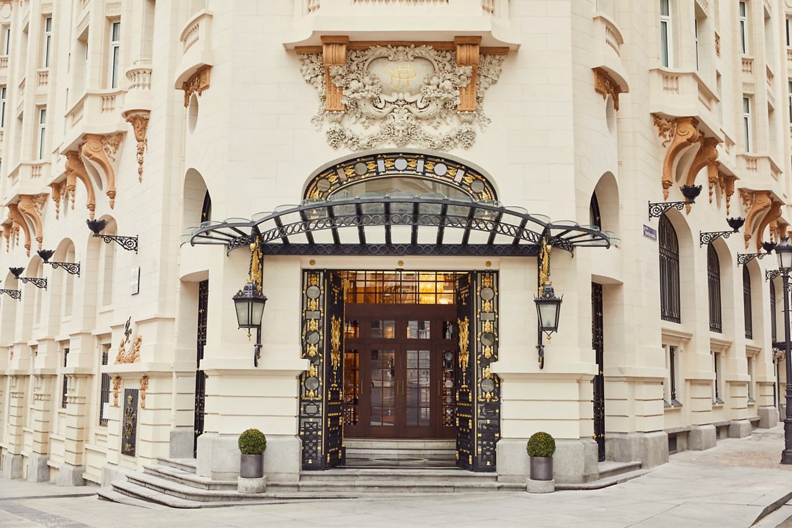 Opulent entrance with gilded accents, intricate carvings and wrought iron fittings