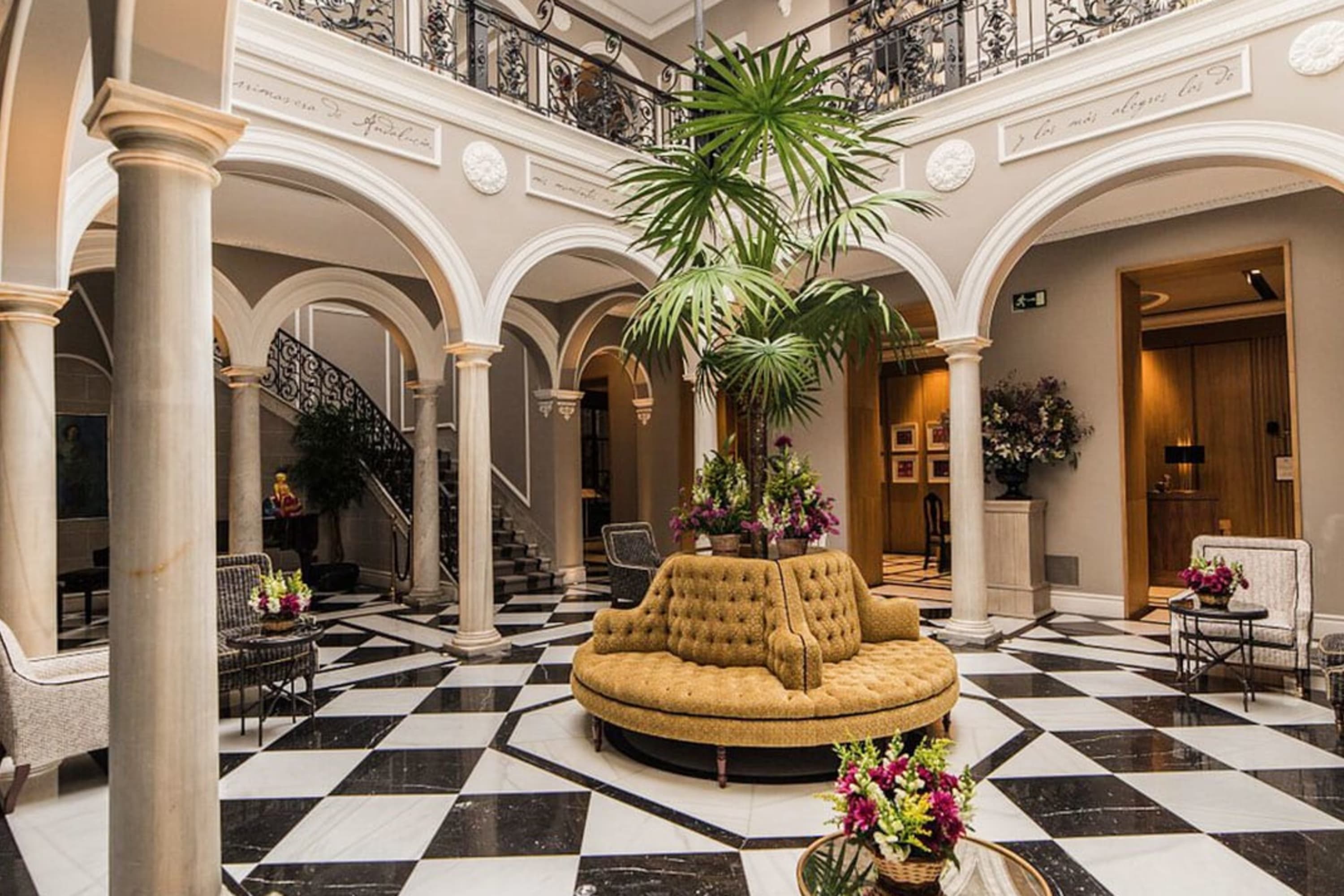 Marble floors, stone columns, posh furniture and potted plants in an elegant lobby area