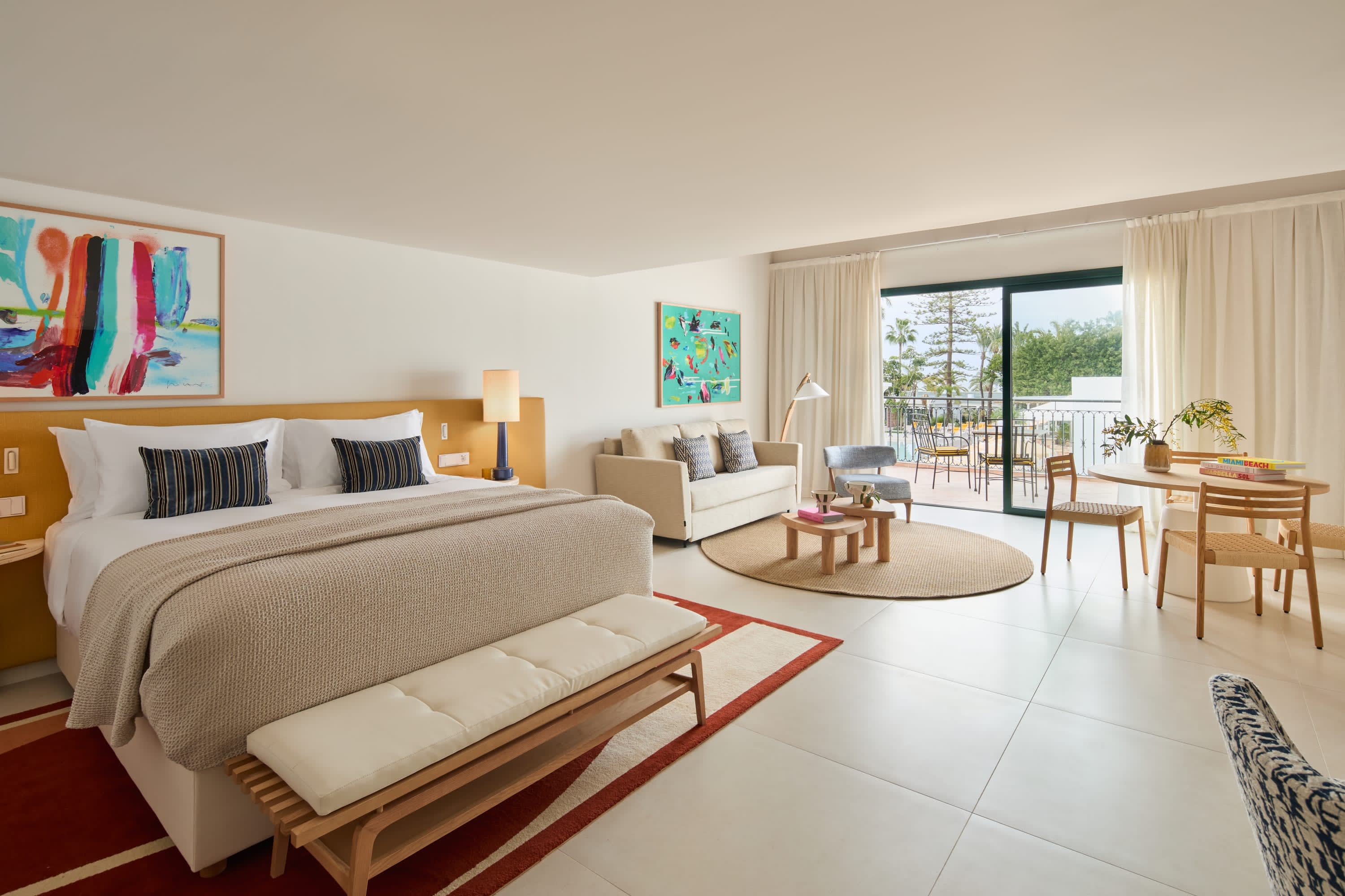 Bright, modern hotel room with plenty of space, fun art and a balcony