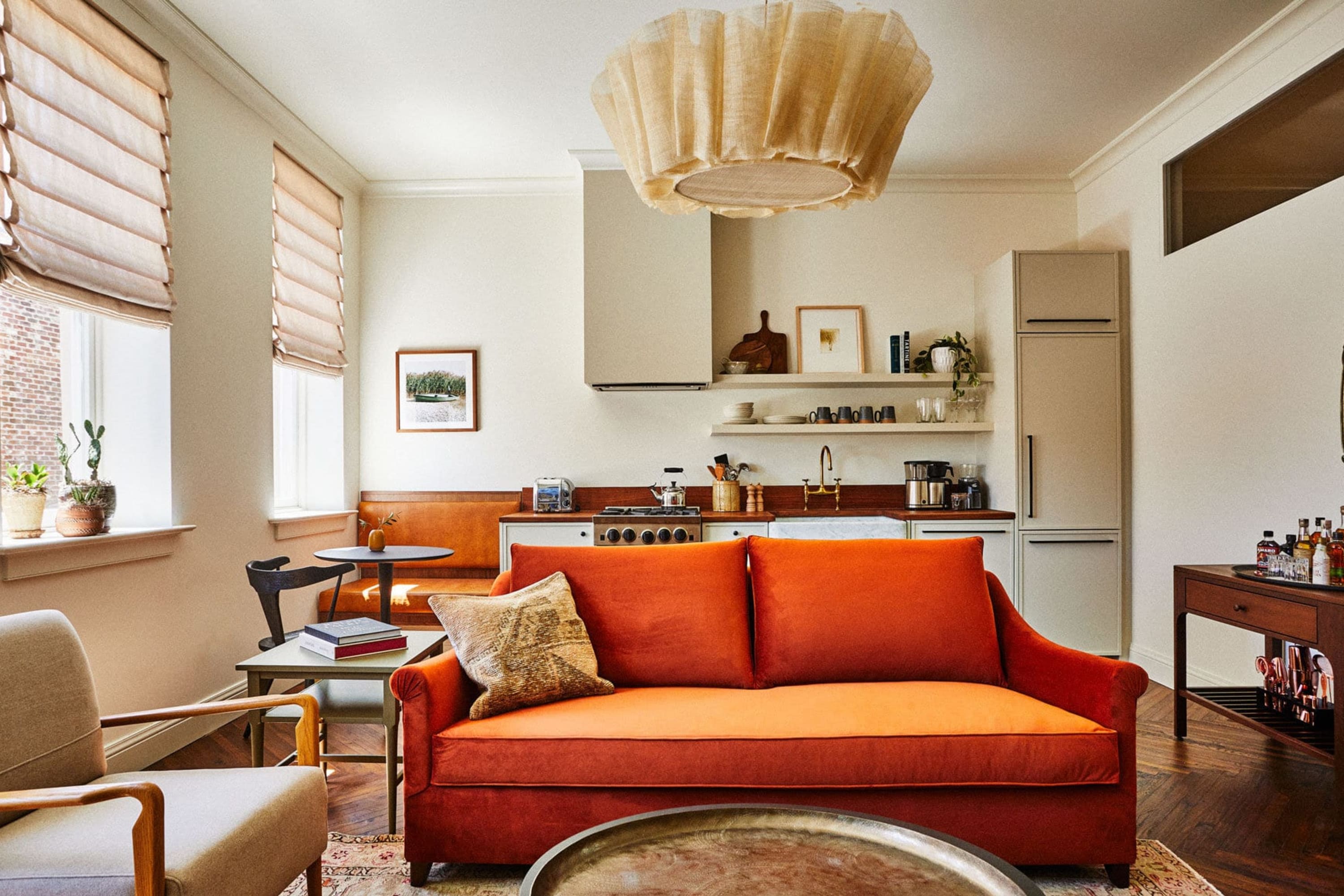 Spacious hotel living room with an attached full kitchen and stylish decor