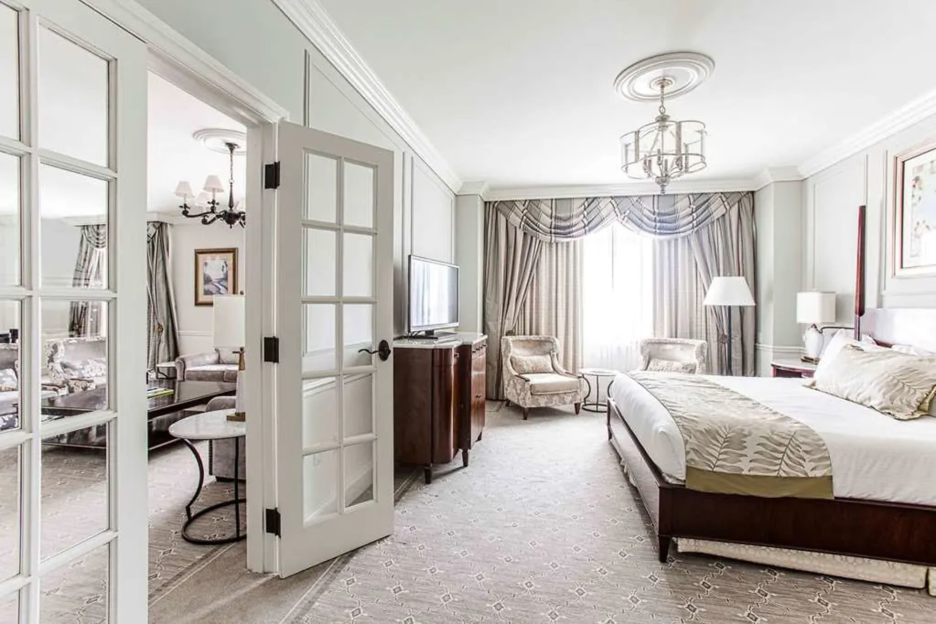Classic whitewashed hotel suite with vintage decor and fine linens