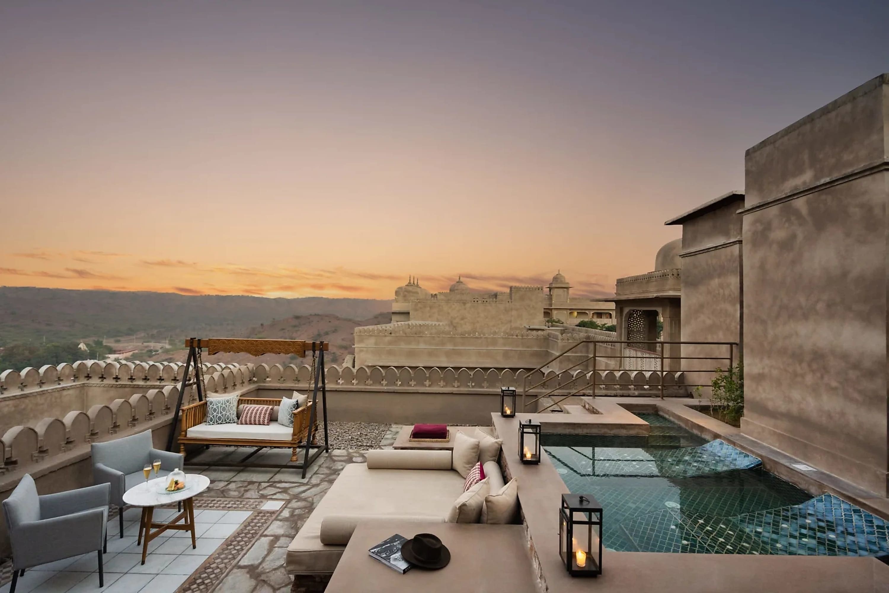 A fortress-like setting with a chic terrace, outdoor furniture and pool, plus a gorgeous sunset view