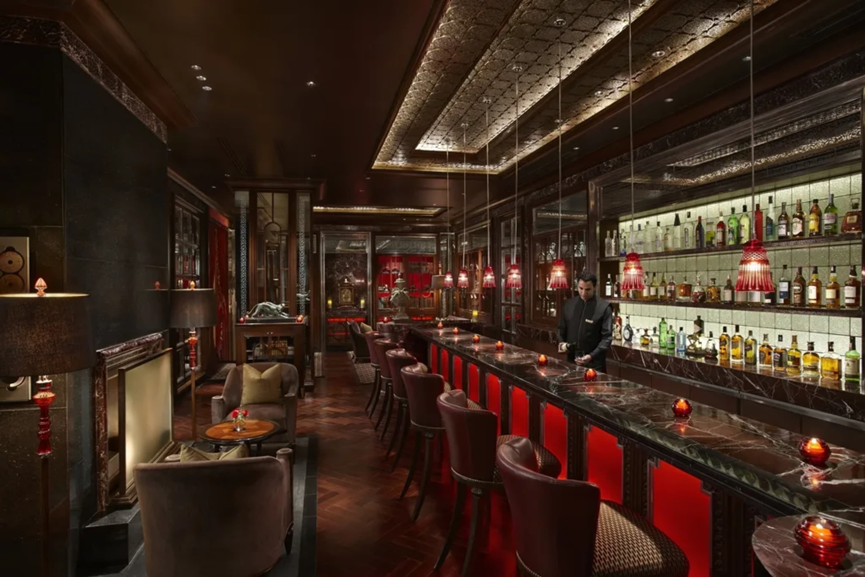 Moody bar with elegant furniture and table setting plus a full selection of liquors and spirits