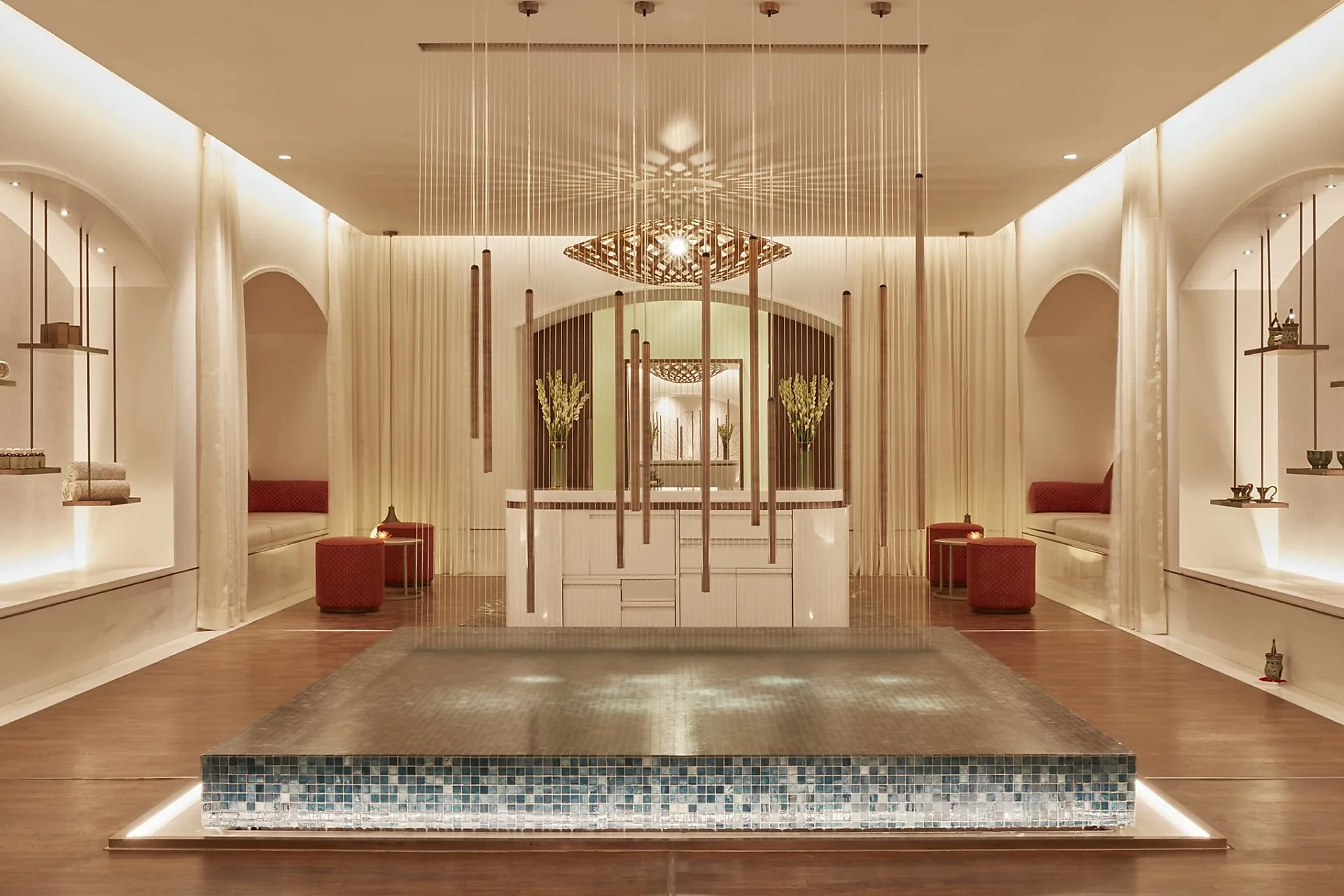 Tranquil, high-end spa with hardwood floors, an infinity water feature and wind chimes hanging from the ceiling