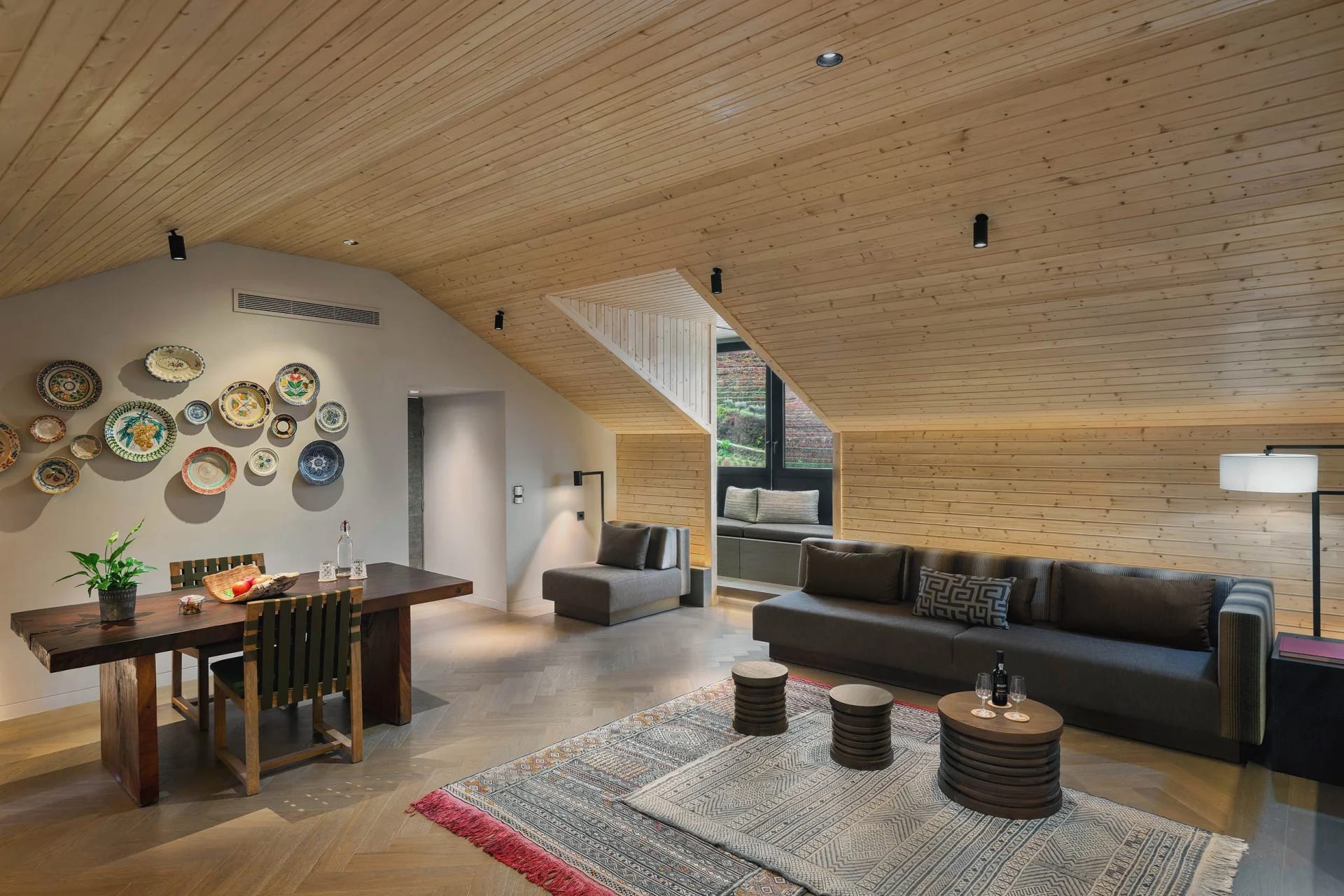 Natural tones, vaulted ceilings, contemporary furniture, rustic decor in a spacious living room