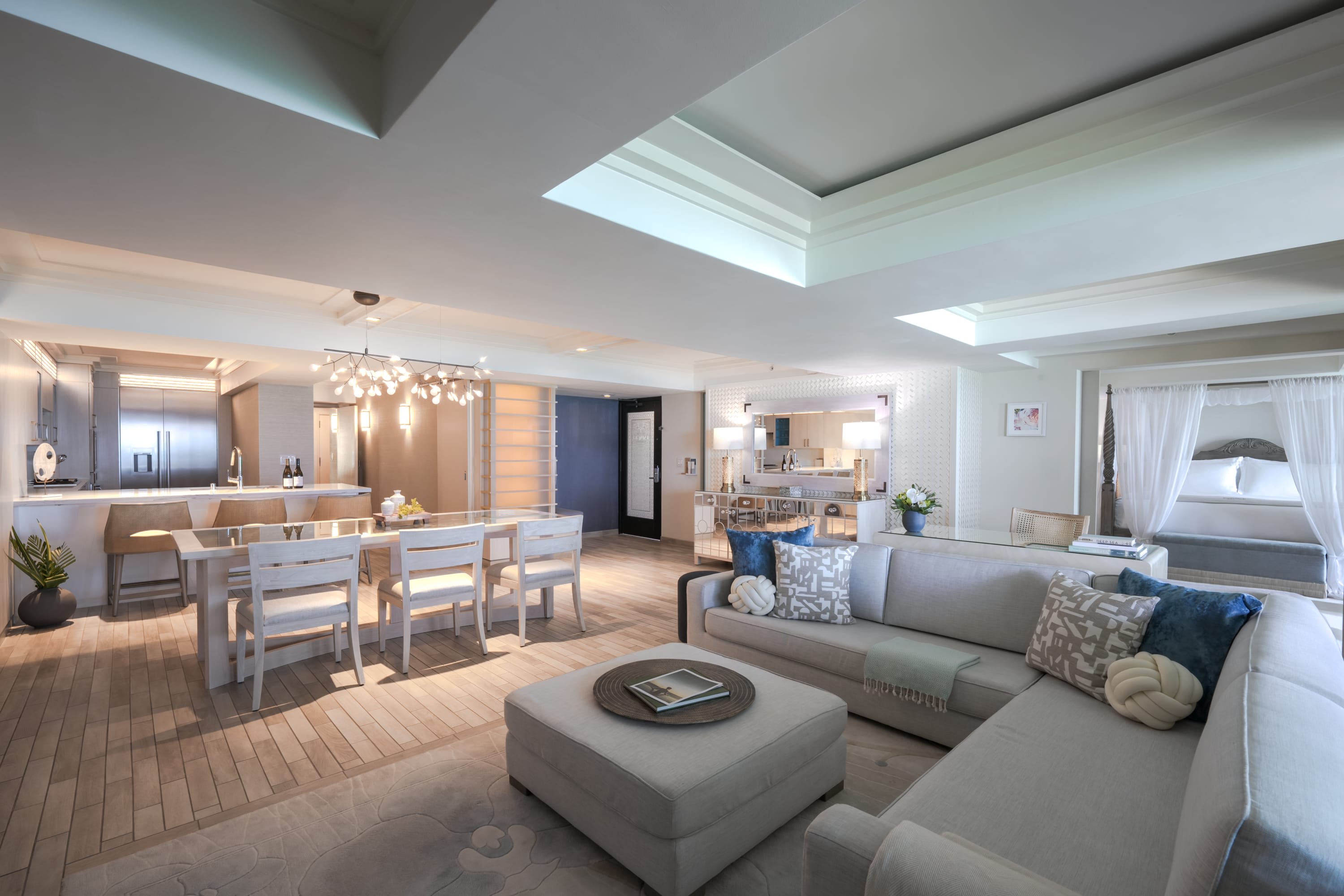 Luxurious suite with whitewashed furniture, blue accents, and chic decor