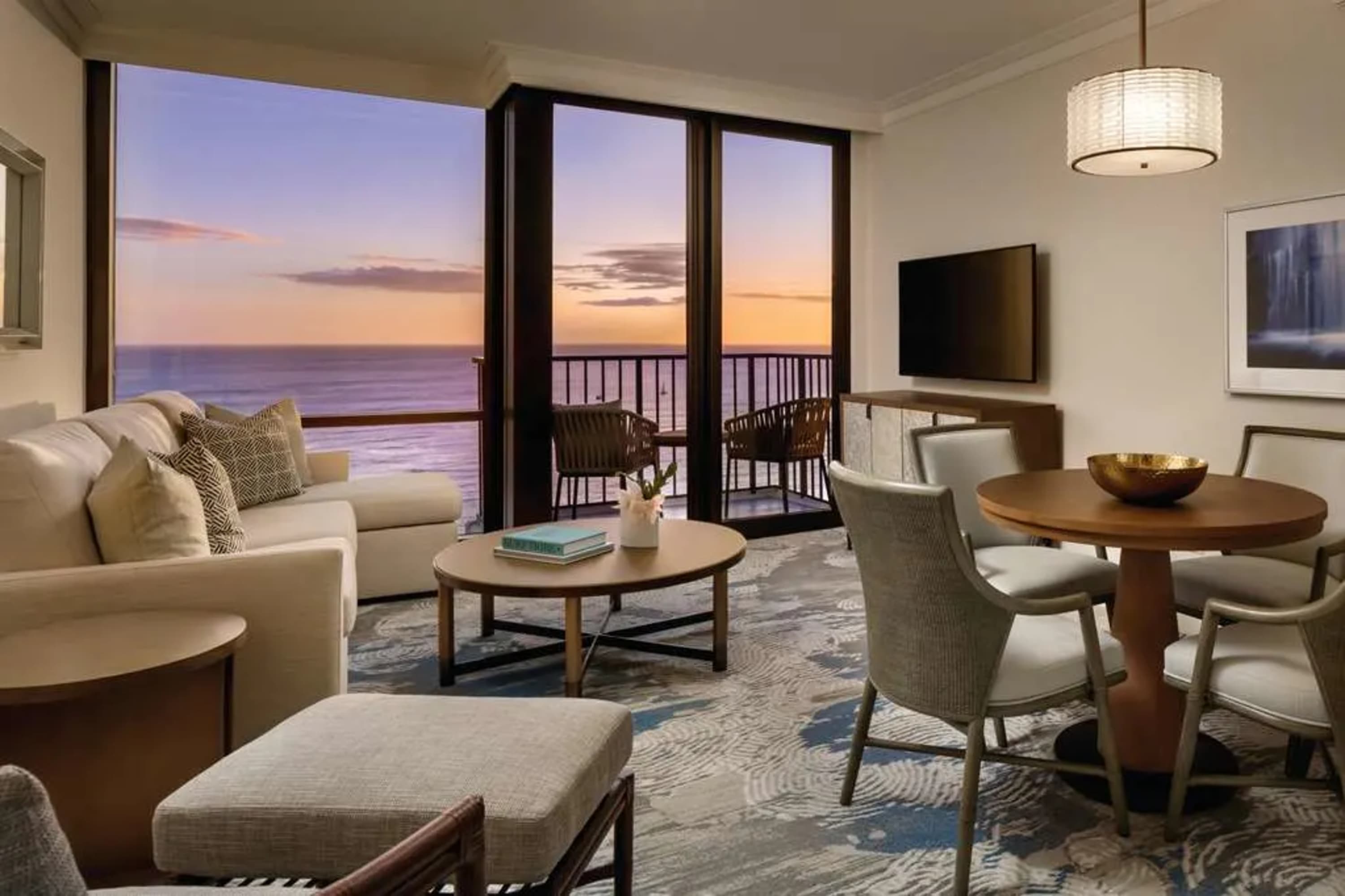 At twilight: mature but stylish luxe suite with a balcony and ocean view