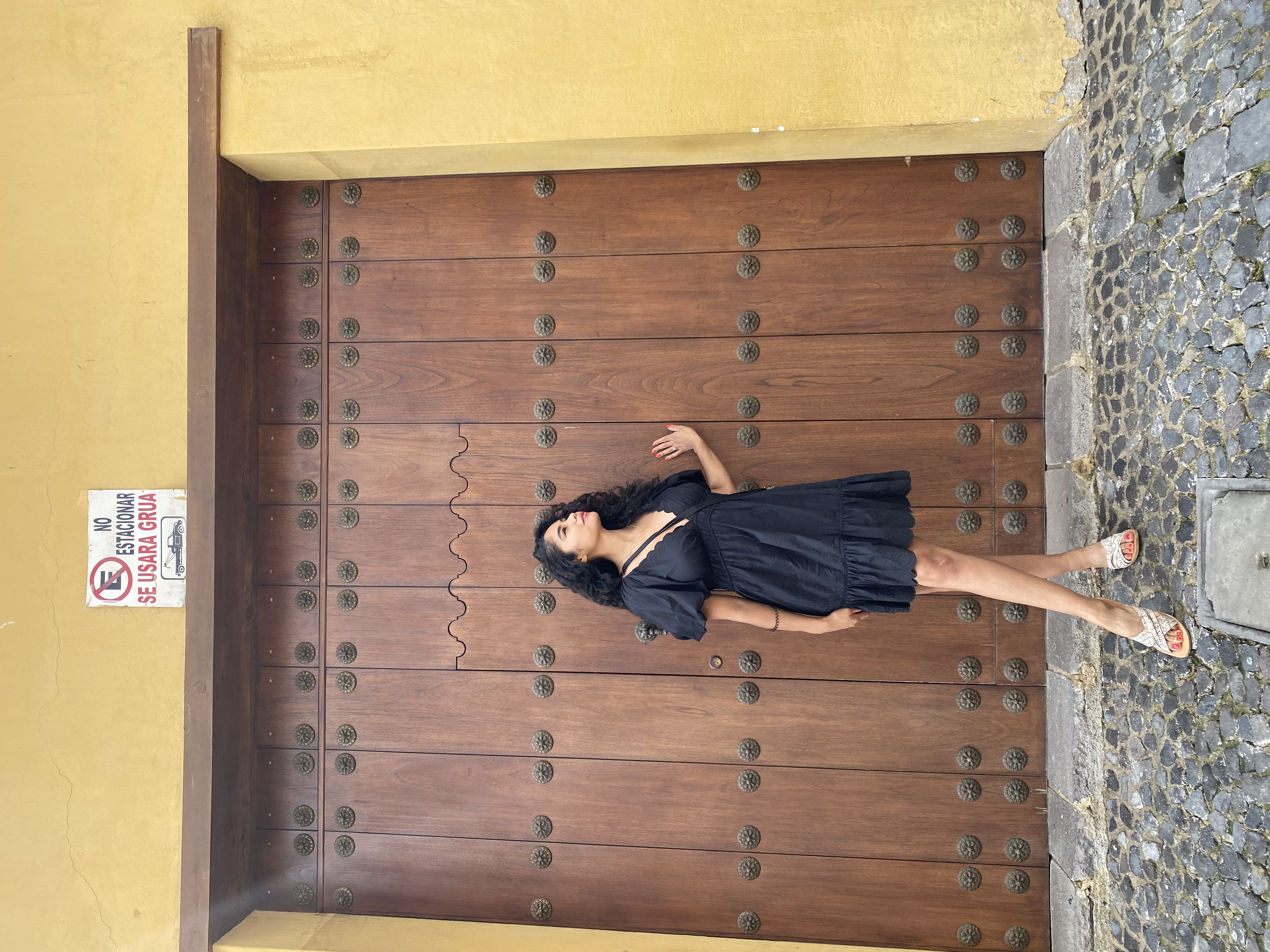 Advisor posing for an image with a blue dress and a wooden door in the background.