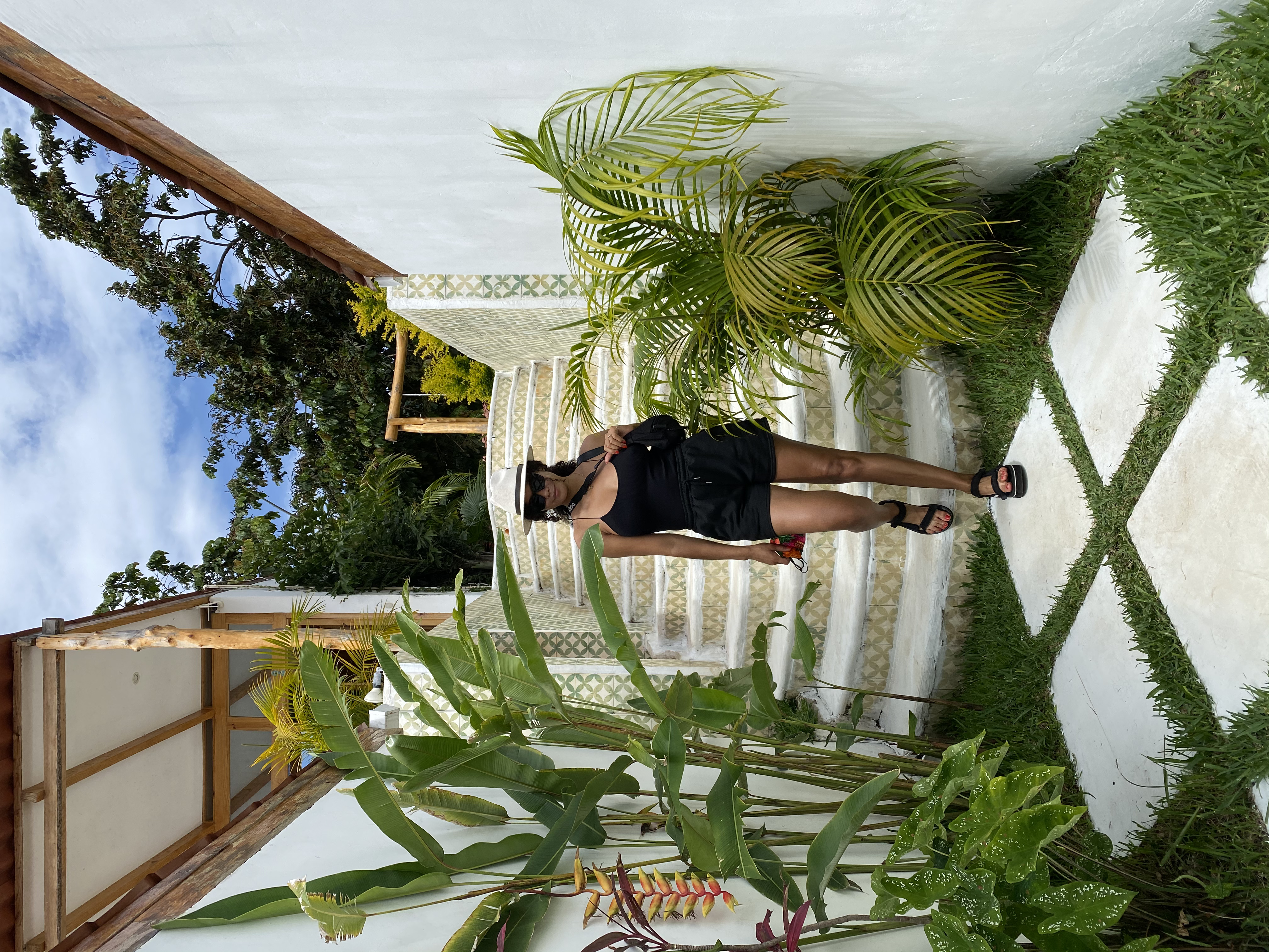 Advisor walking down the stairs with foliage on a sunny day.