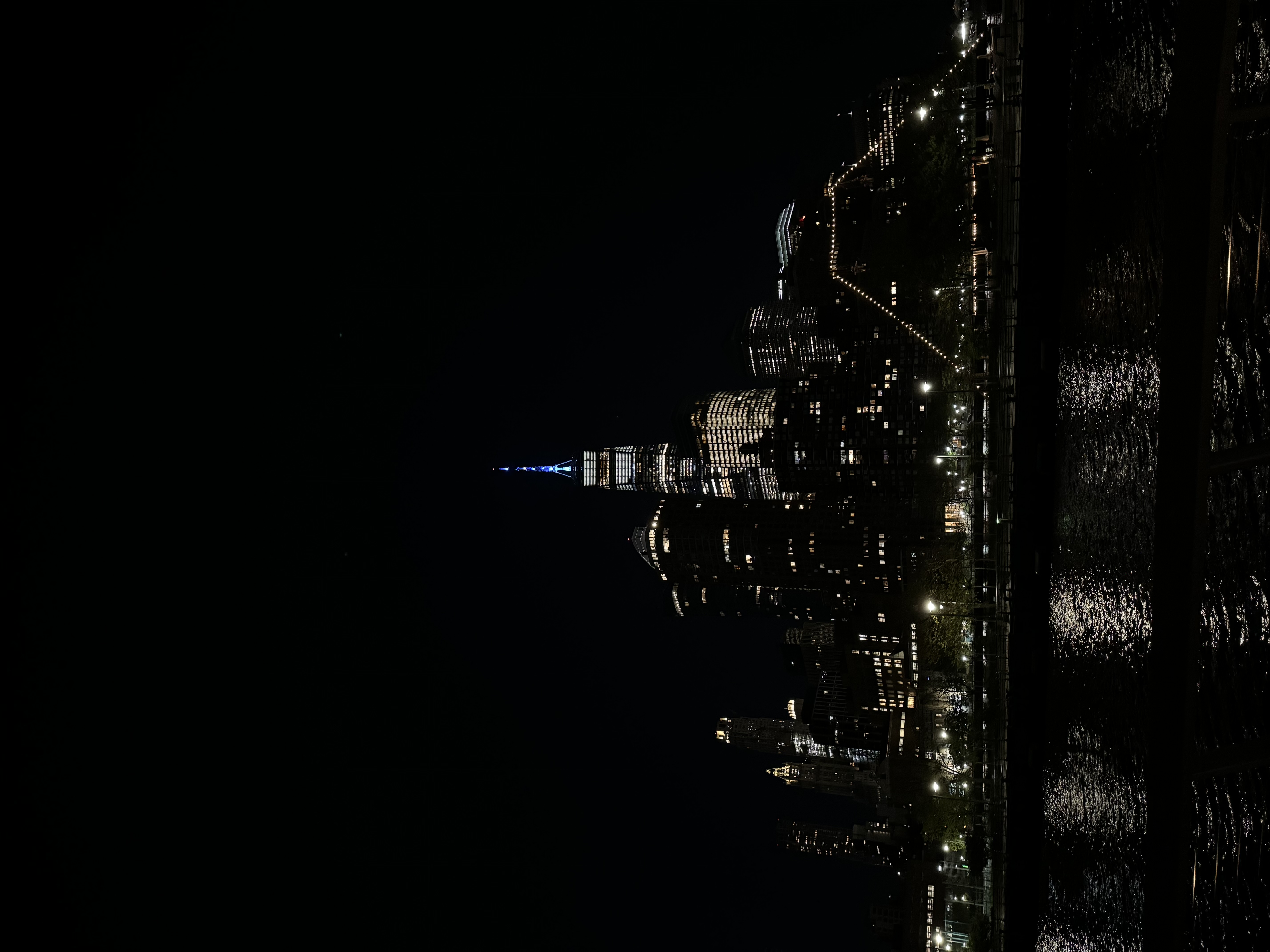 An image at night of a city with bright lights.