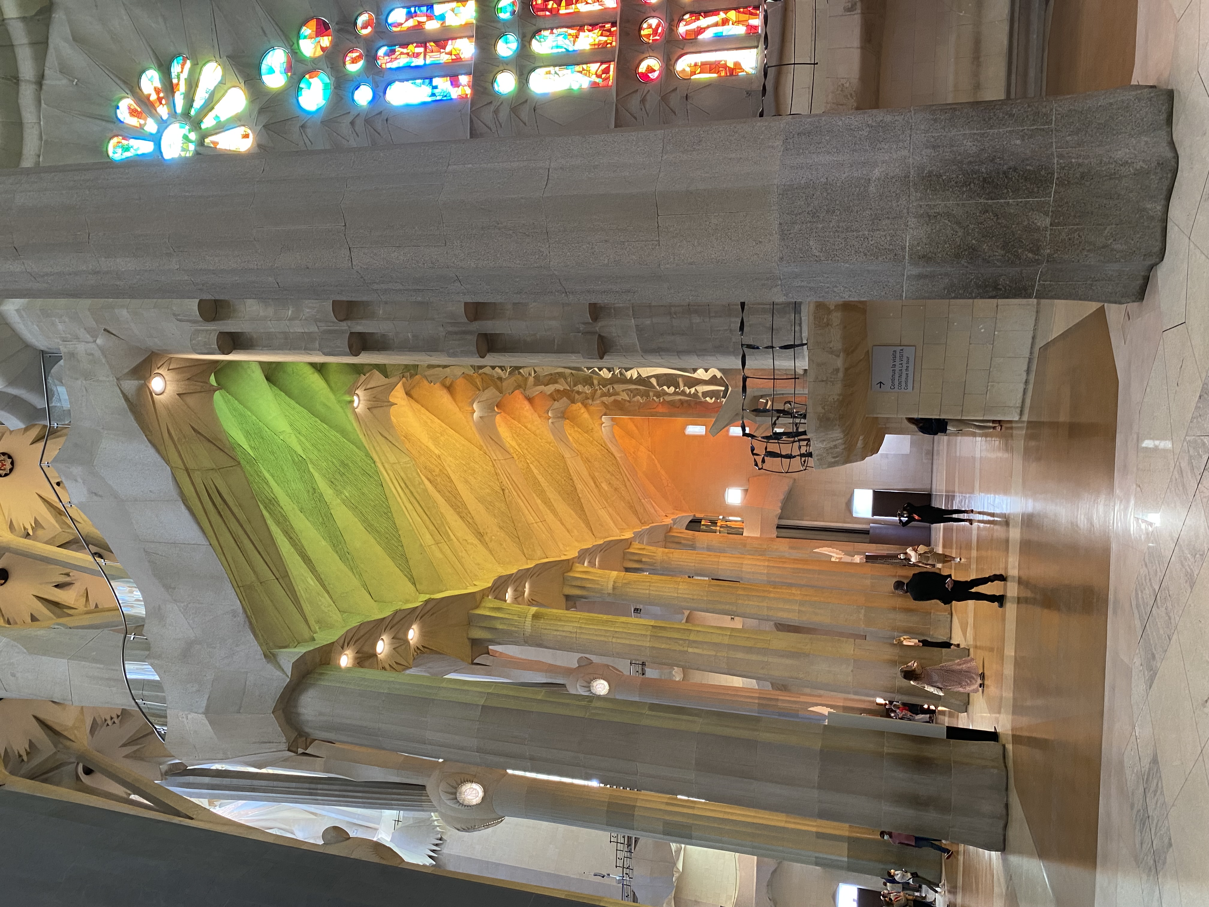 View of the inside of a grand cathedral with colorful stained glass windows